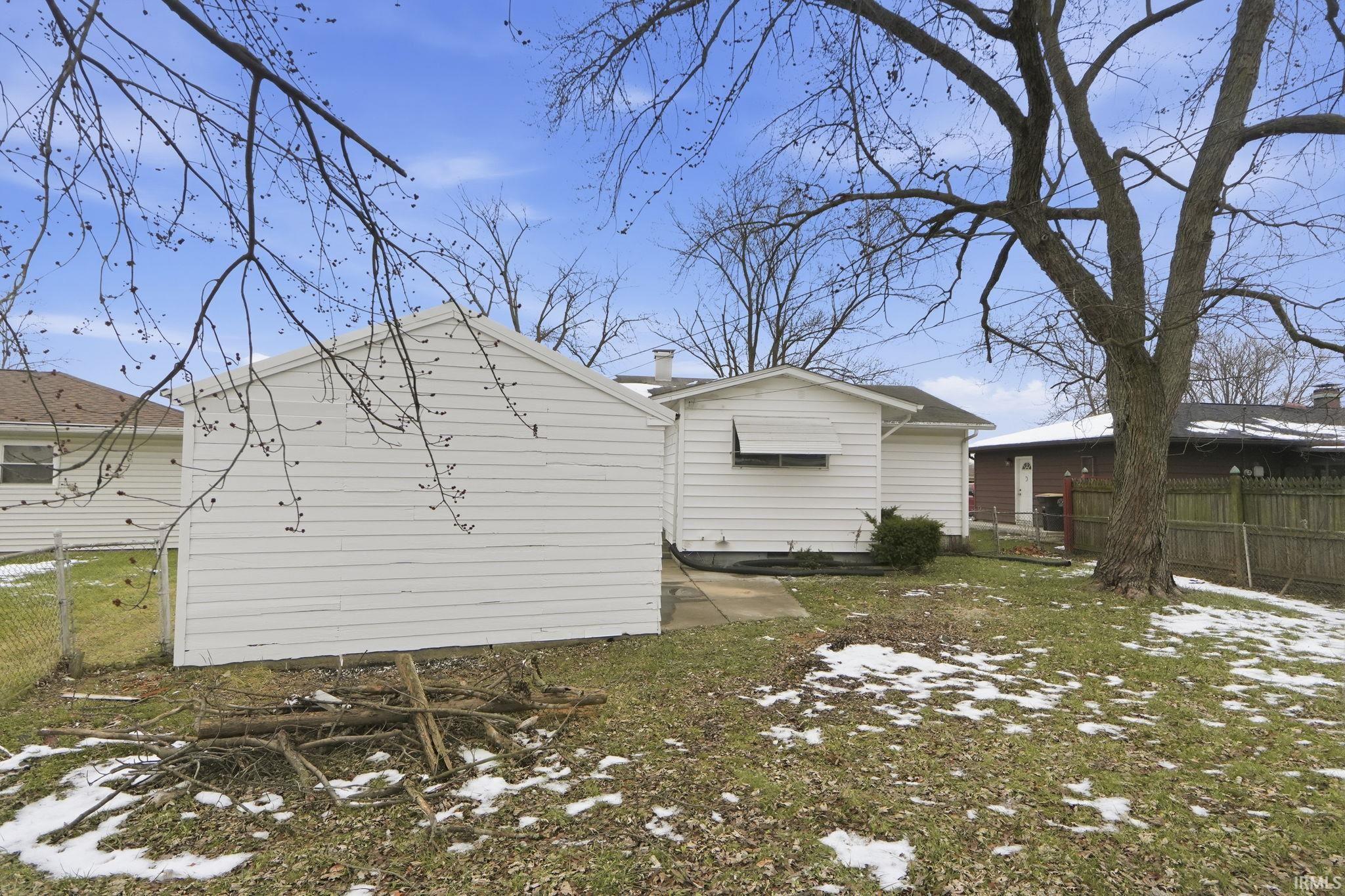 View of snow covered exterior with a chimney