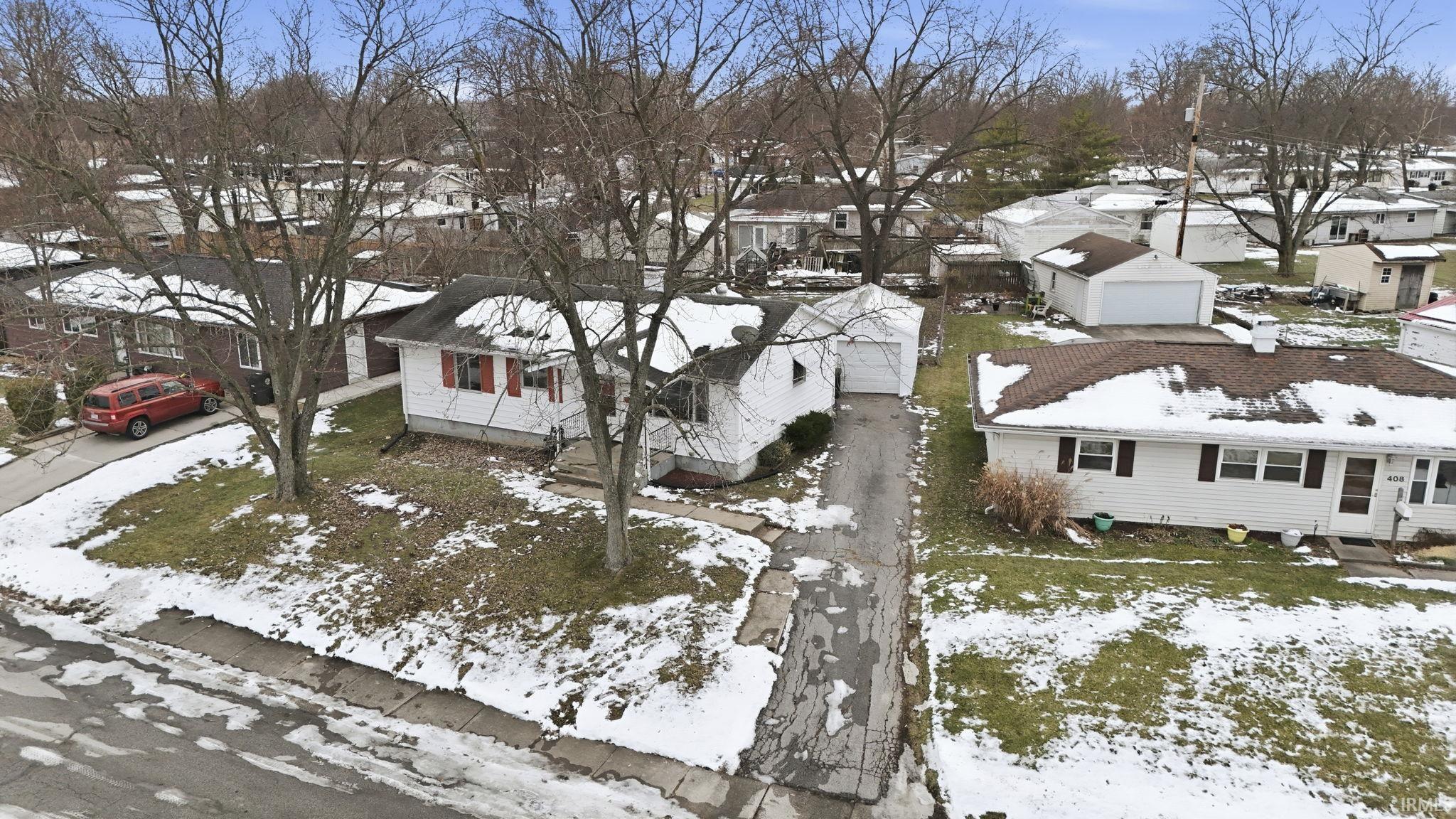 Snowy aerial view featuring a residential view