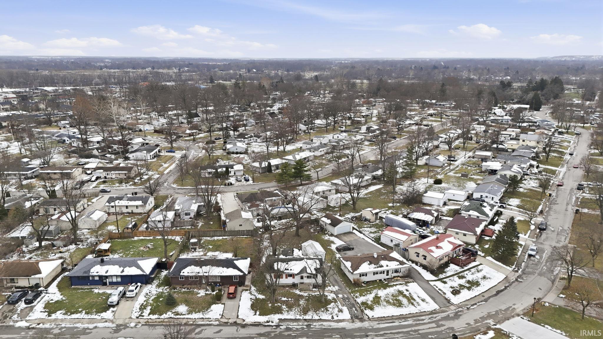 Aerial overview of property's location featuring nearby suburban area