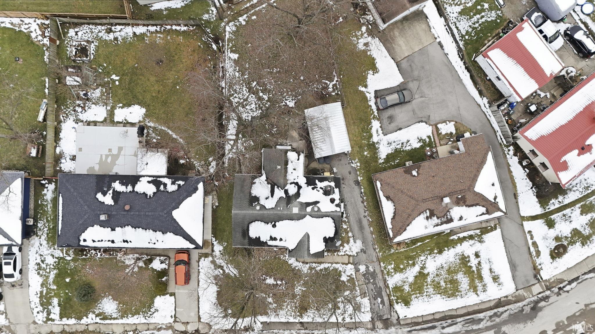 Snowy aerial view featuring a residential view