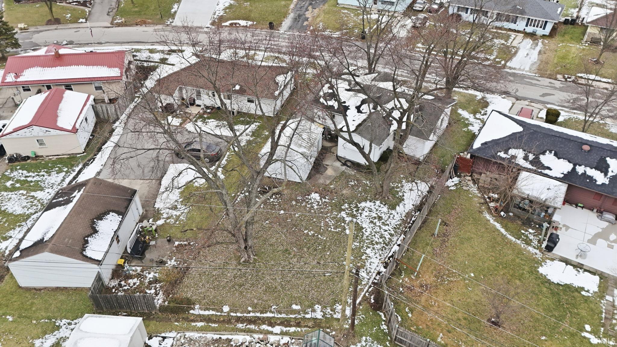 Aerial view of property and surrounding area with nearby suburban area