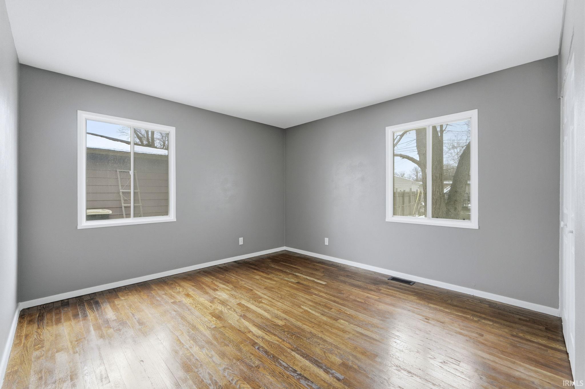 Spare room featuring light wood finished floors and healthy amount of natural light