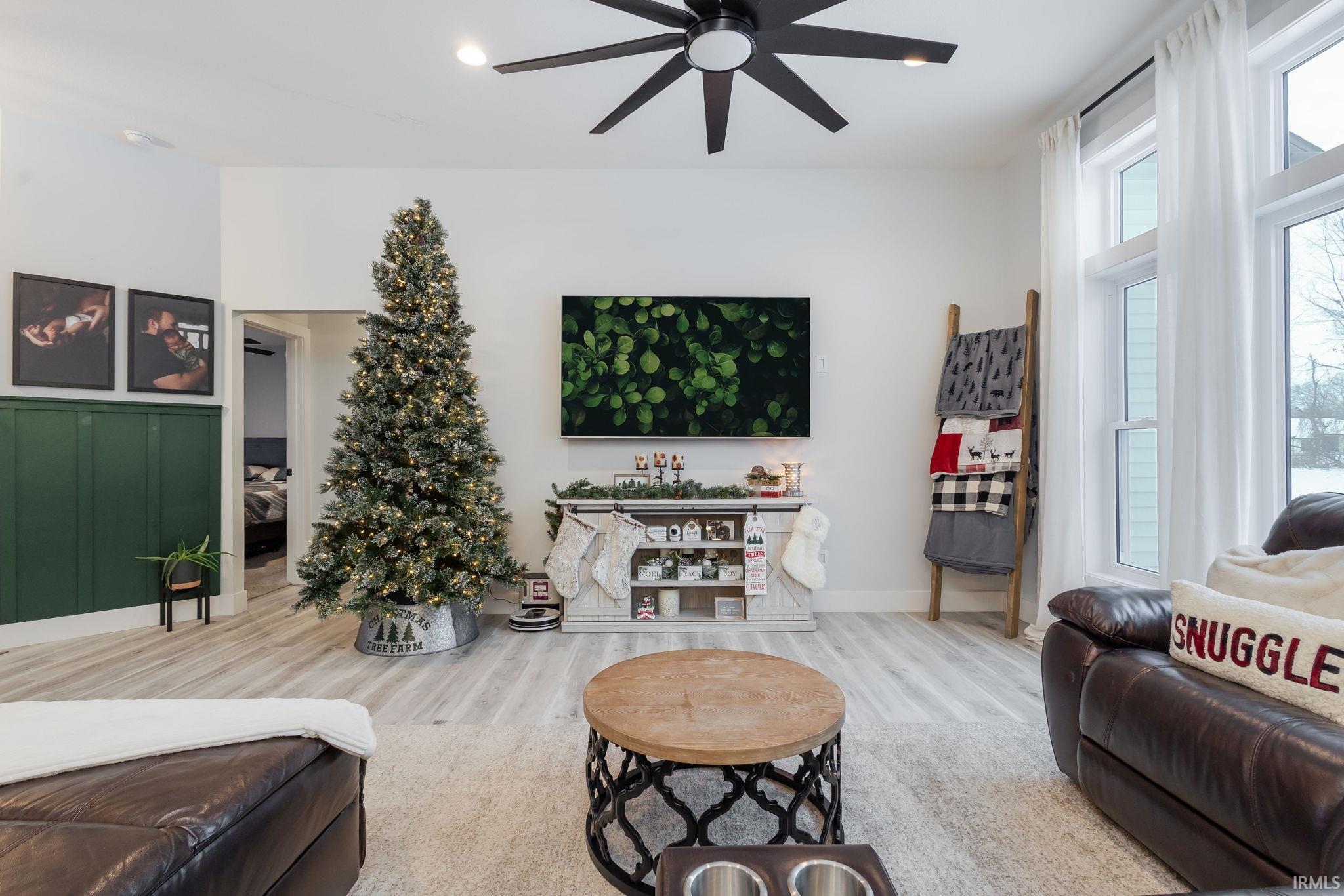 Living area with a ceiling fan and wood finished floors