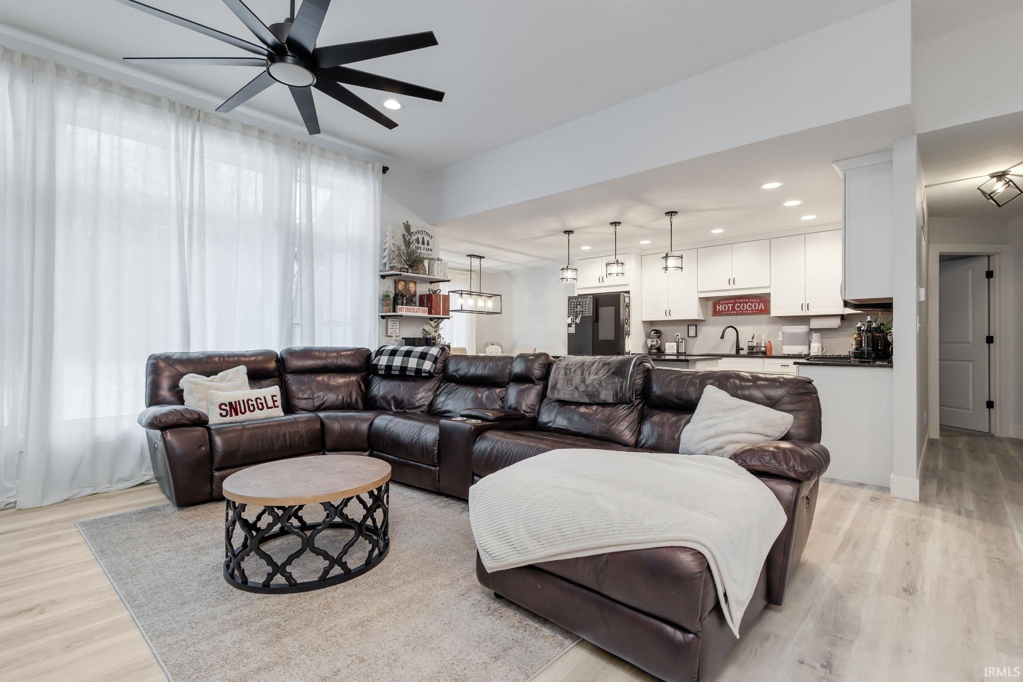 Living room featuring recessed lighting, light wood-type flooring, and ceiling fan