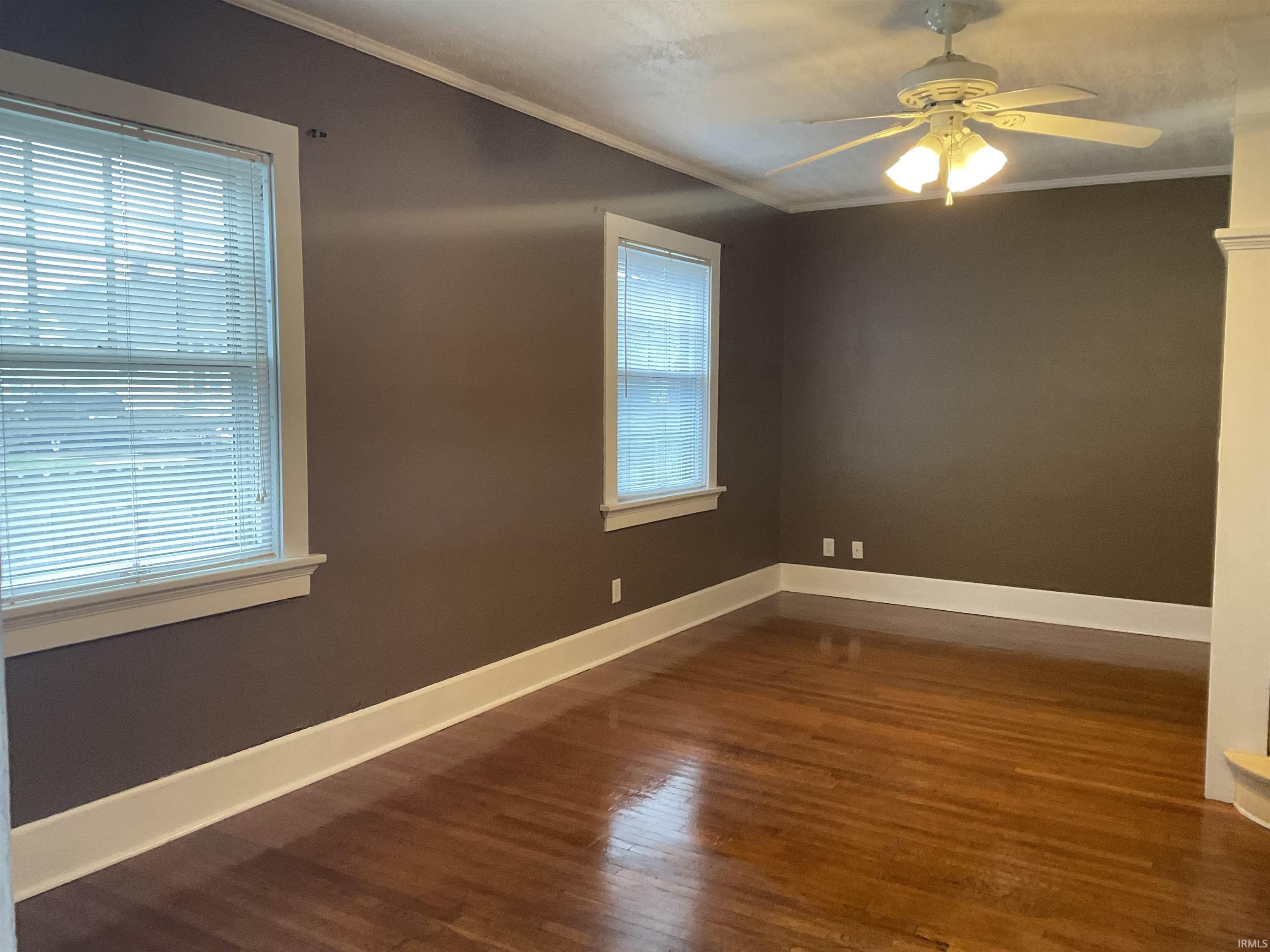Living room with hardwood floors and a ceiling fan