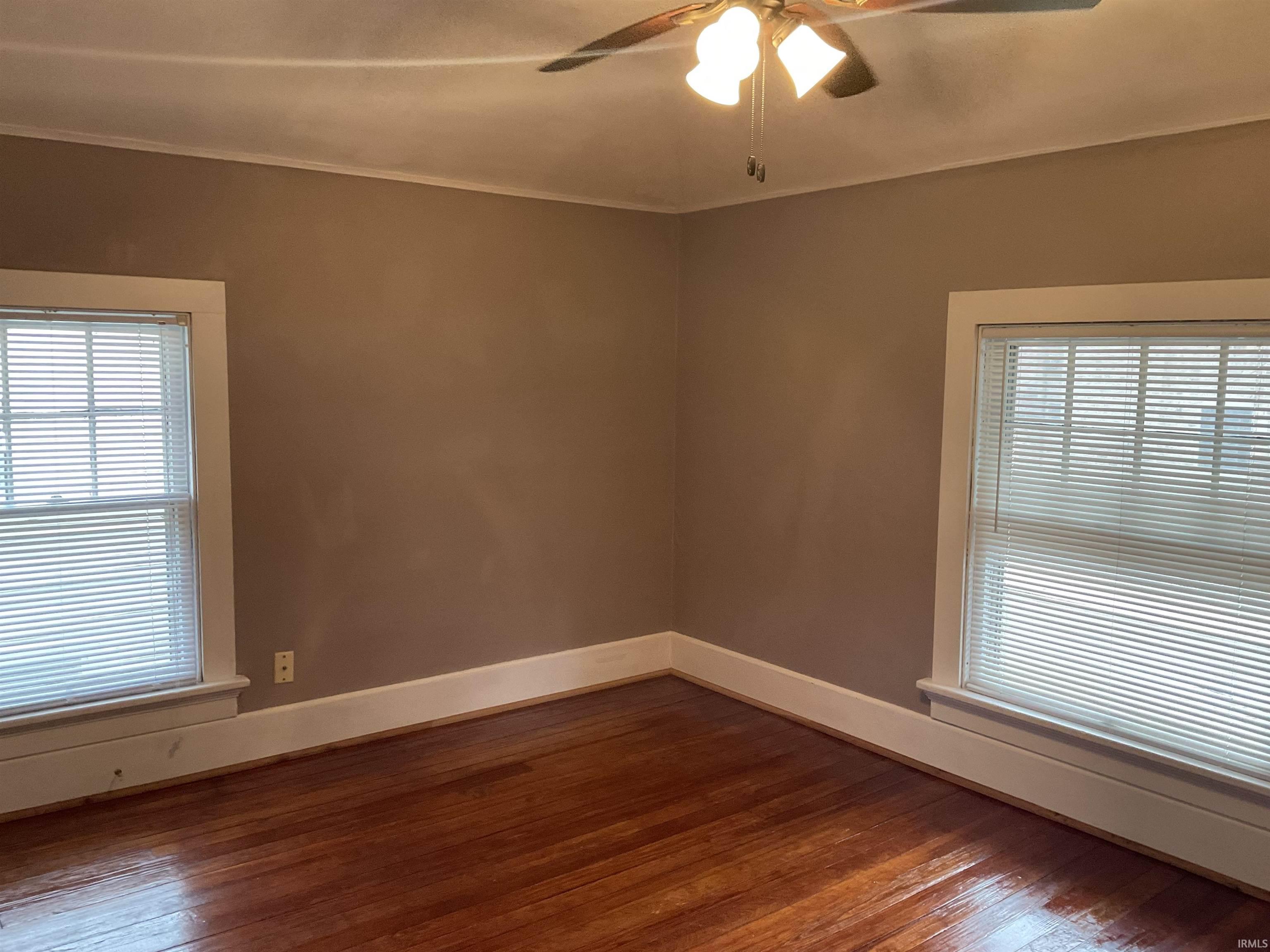Bedroom featuring a ceiling fan and hardwood floors.