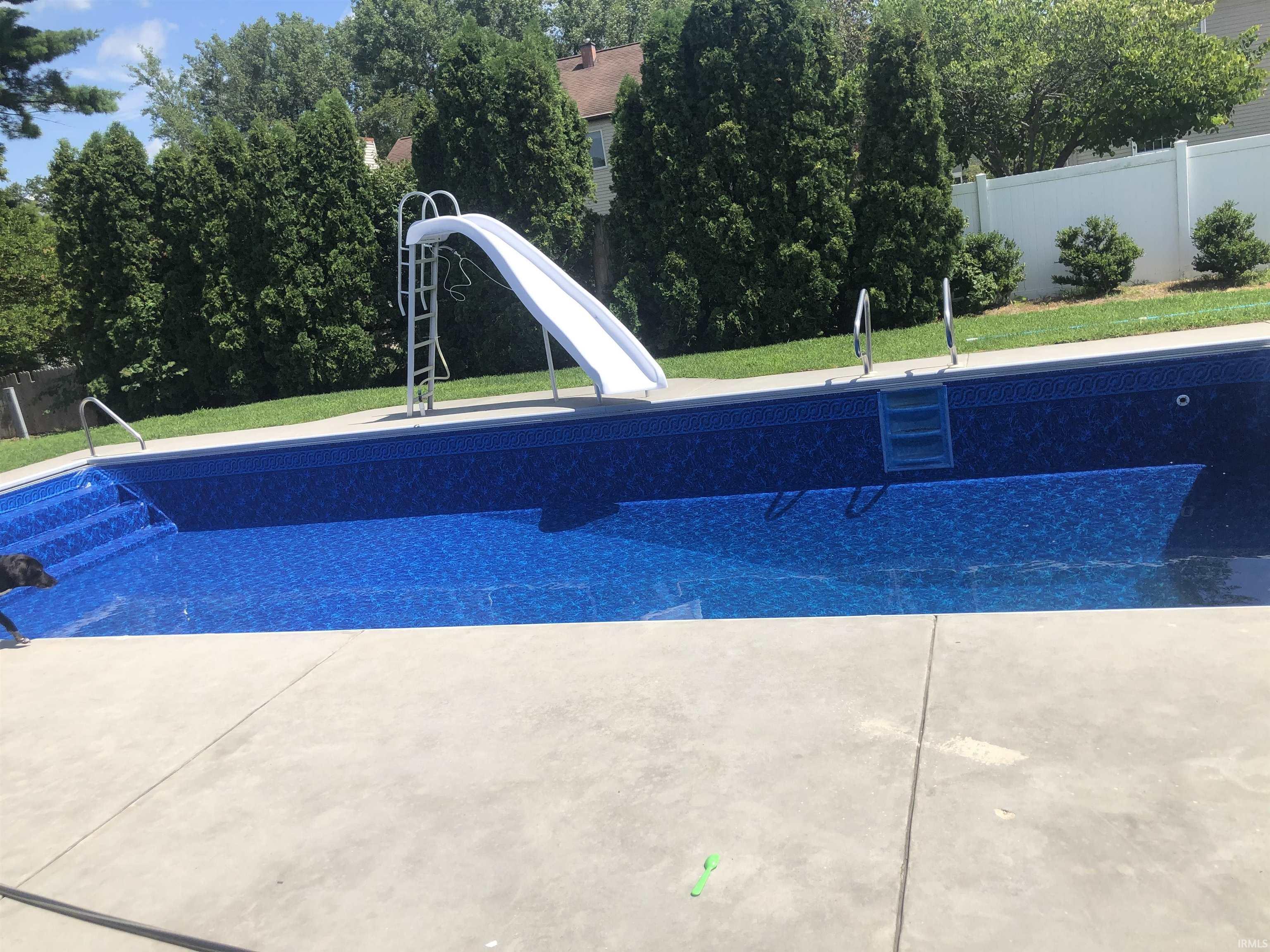 View of swimming pool featuring a water slide