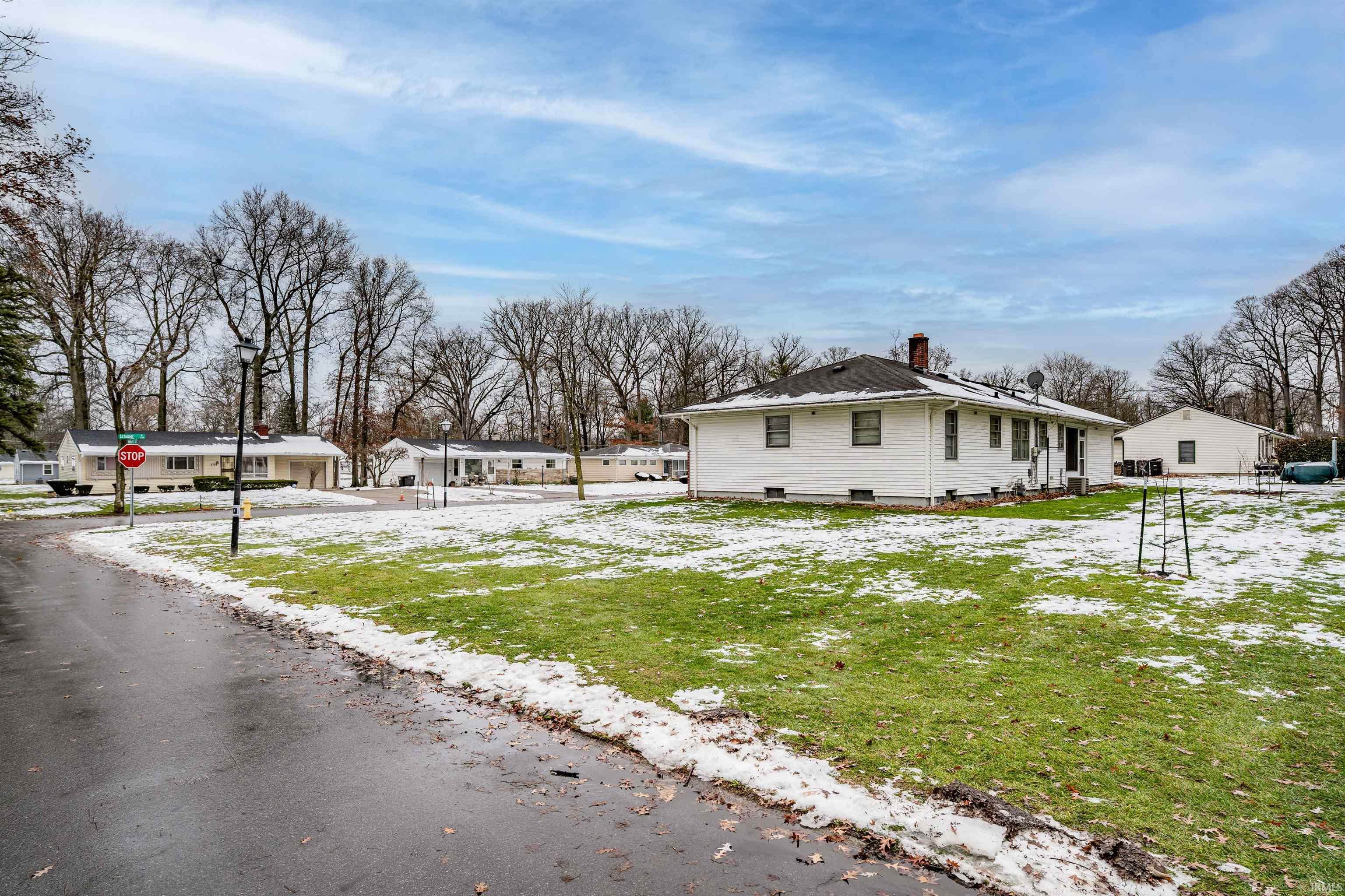 View of snow covered exterior featuring a chimney