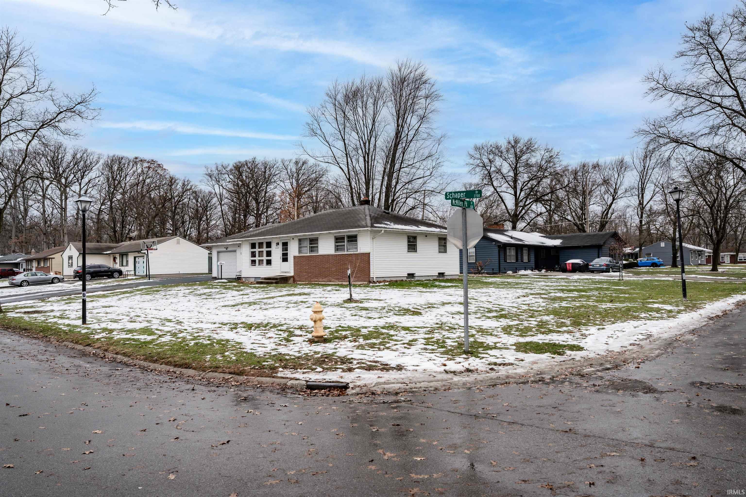 View of front facade with a garage and a chimney
