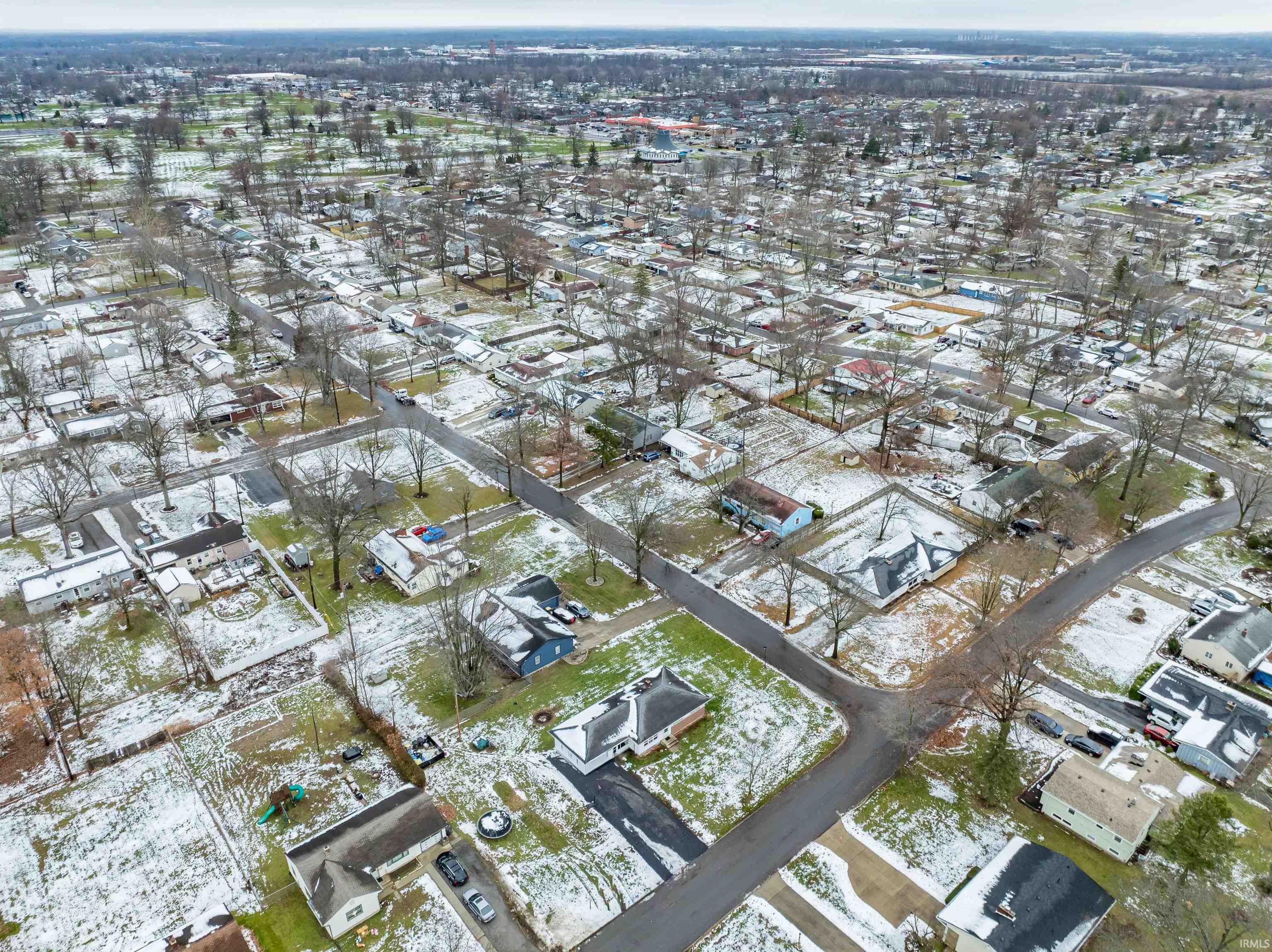 Aerial view of property's location featuring nearby suburban area