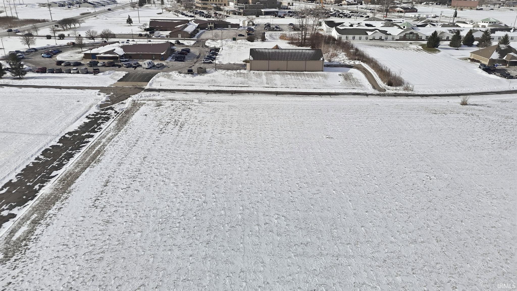 Snowy aerial view featuring a residential view