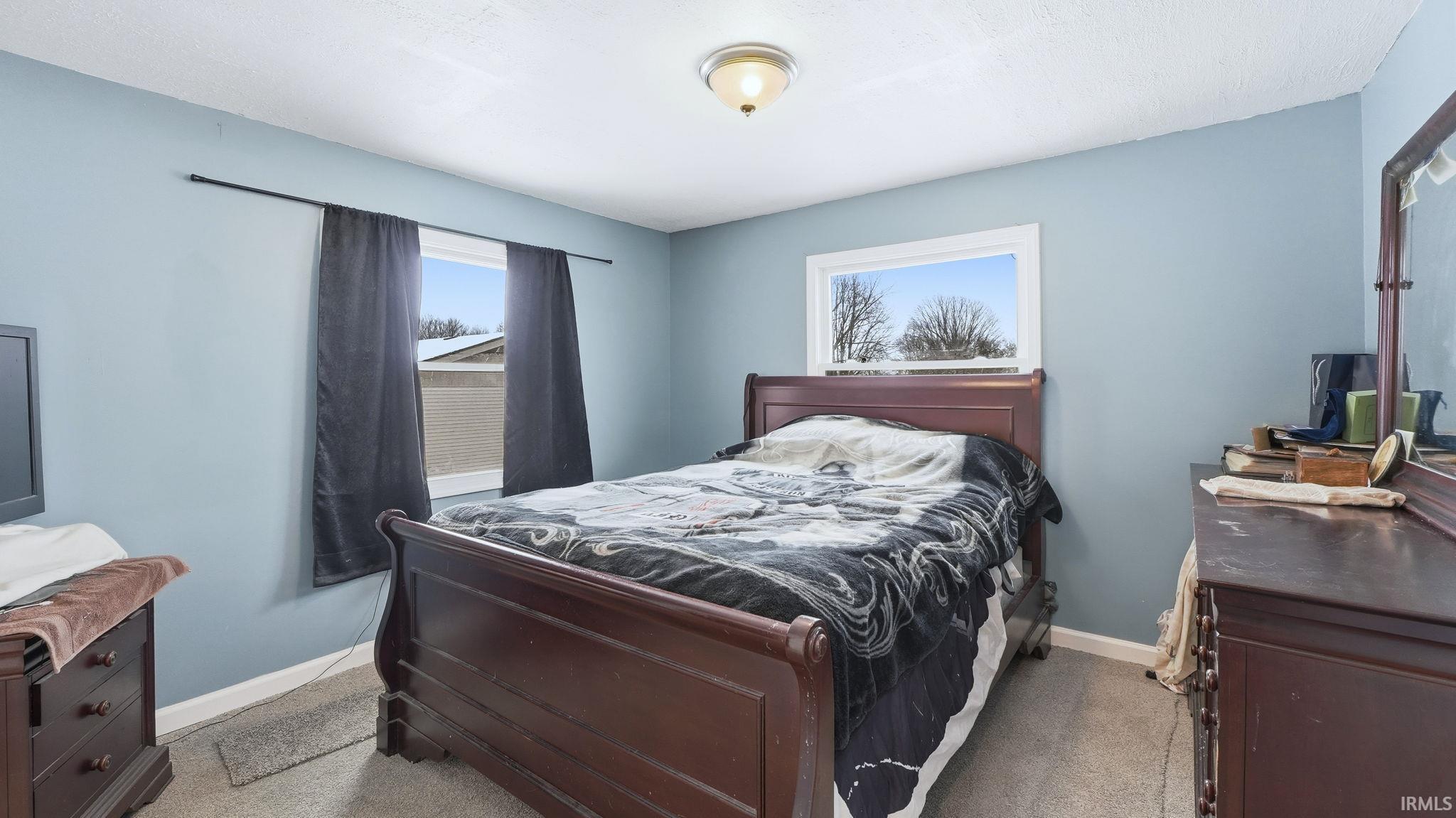 Carpeted bedroom featuring baseboards