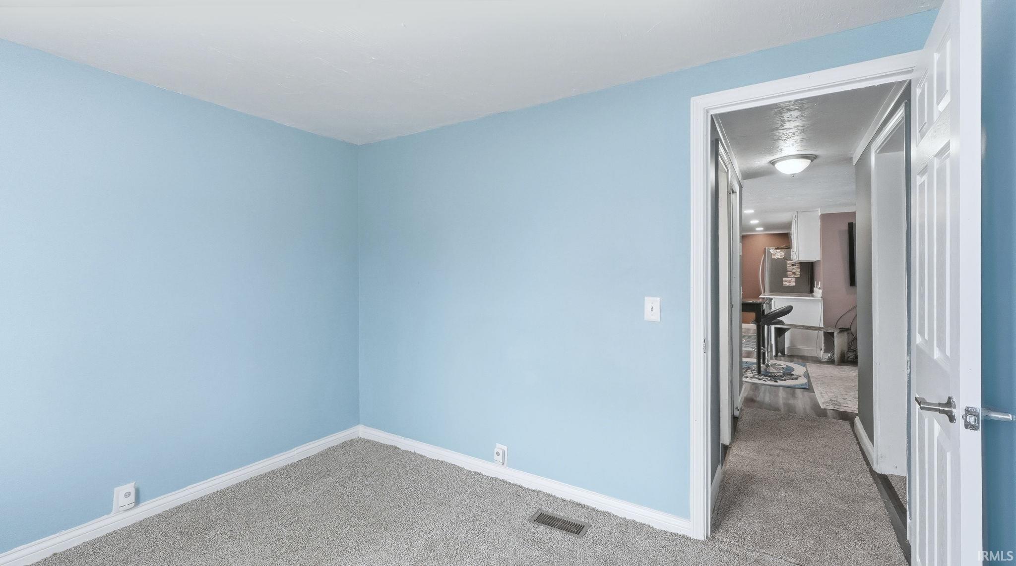 Spare room featuring carpet flooring