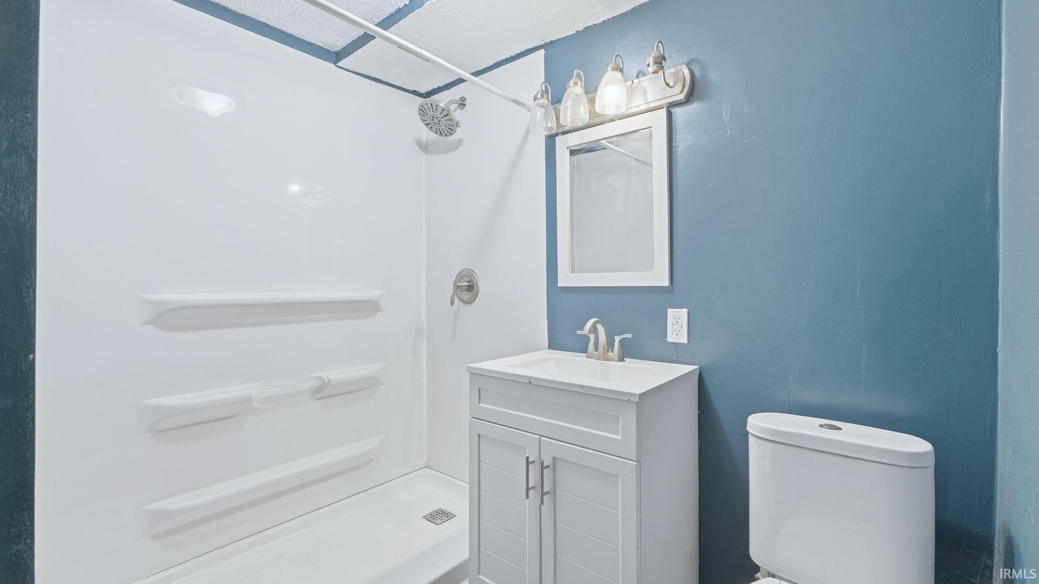 Bathroom with a stall shower and vanity