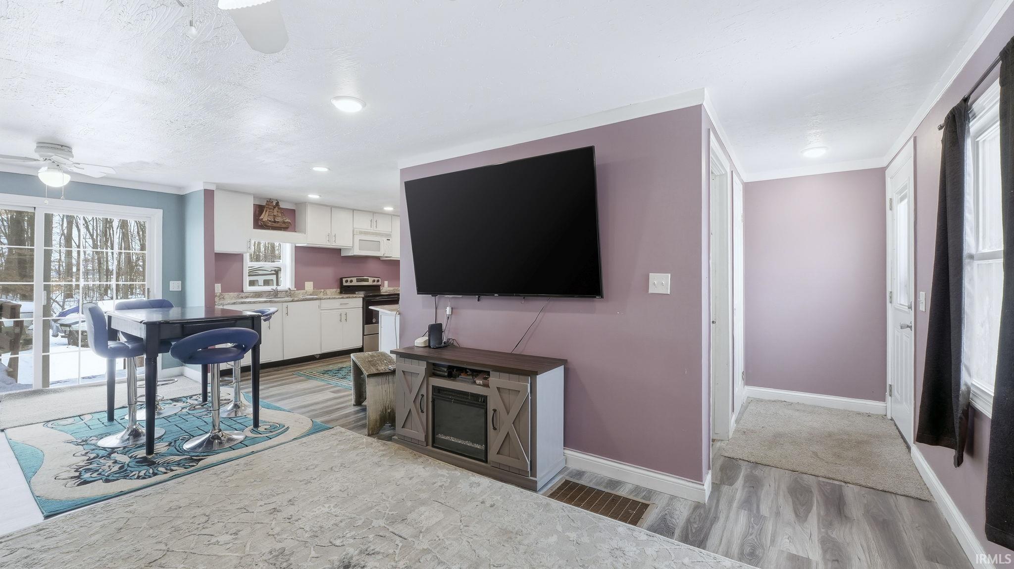 Living room featuring light wood finished floors and ceiling fan
