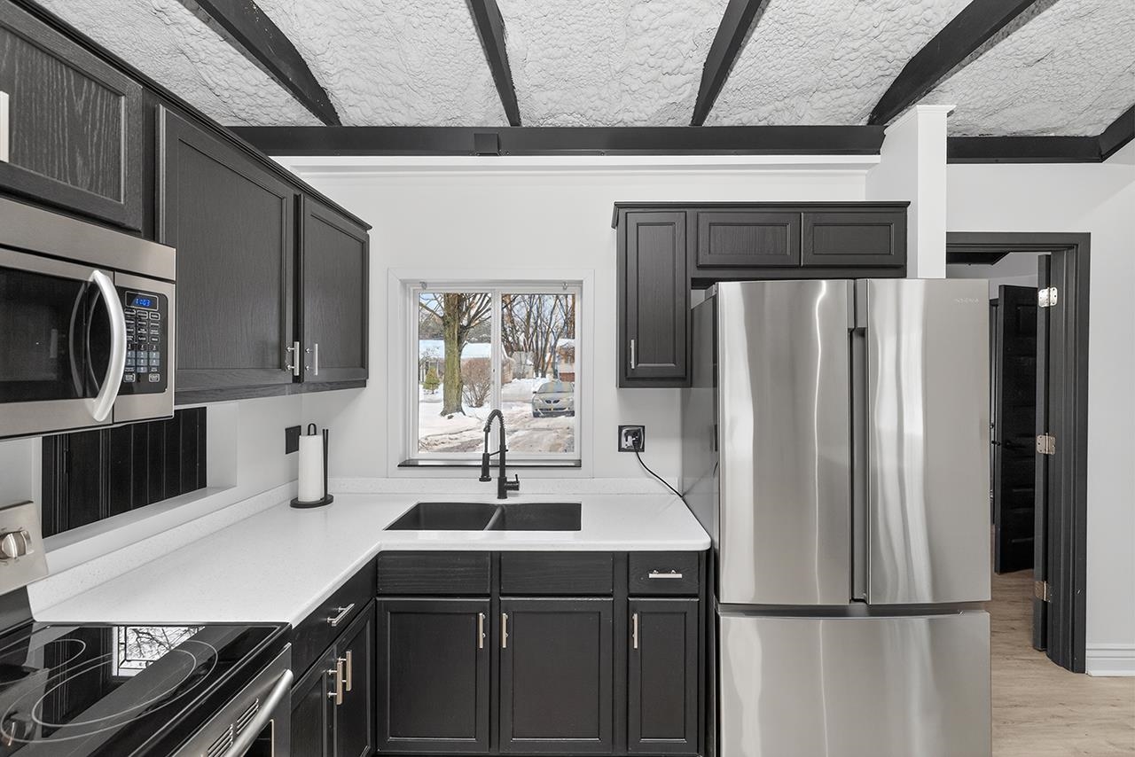 Kitchen featuring appliances with stainless steel finishes and light wood finished floors