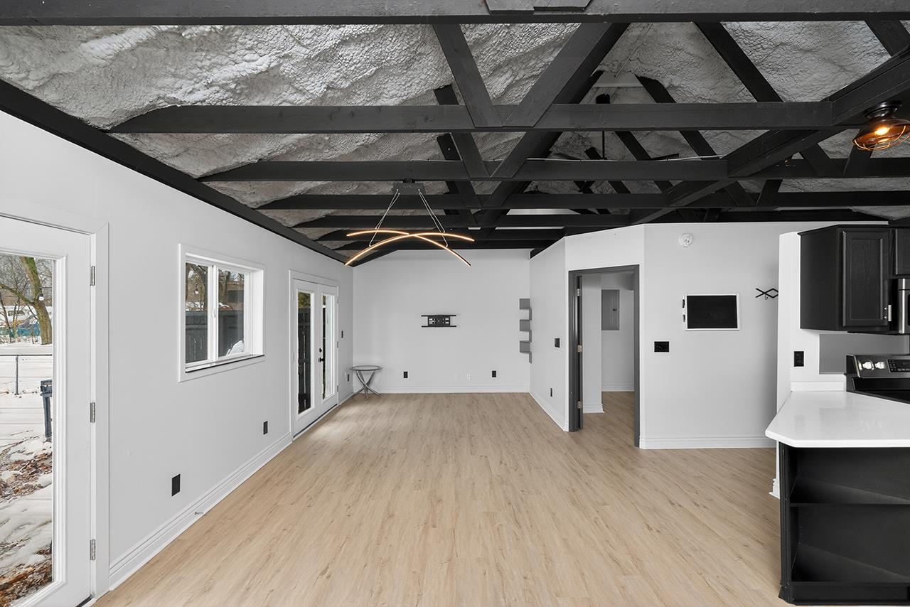 Unfurnished living room with light wood-type flooring and electric panel