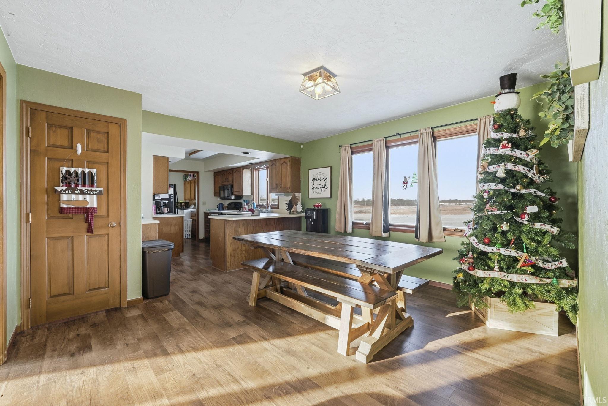 Dining space with dark wood-style floors and a textured ceiling
