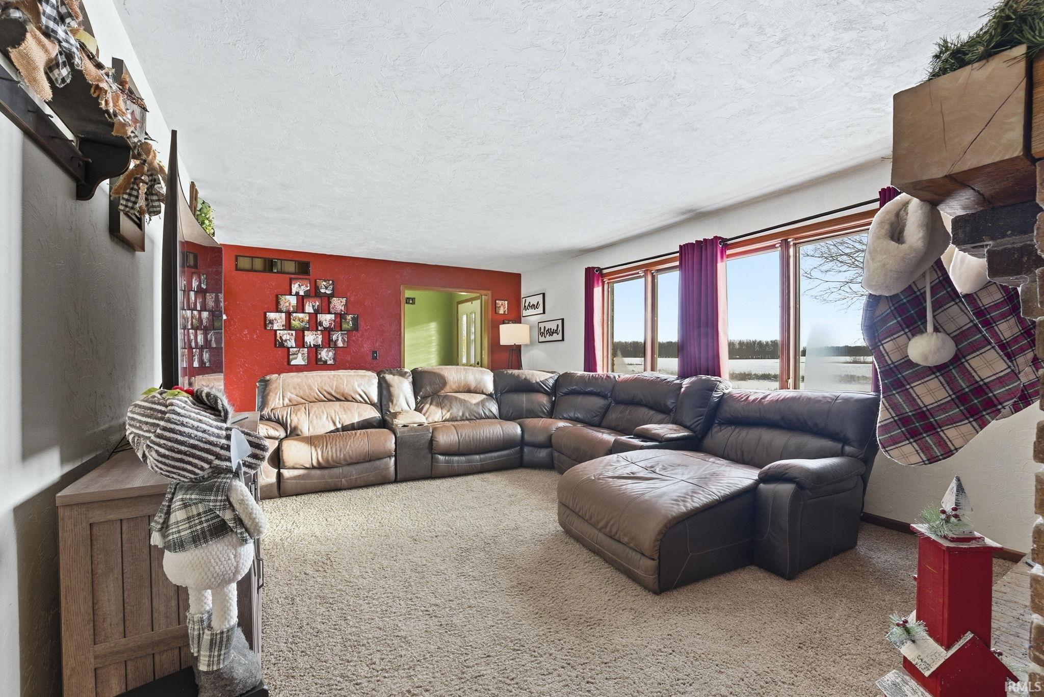 Carpeted living room with a textured ceiling