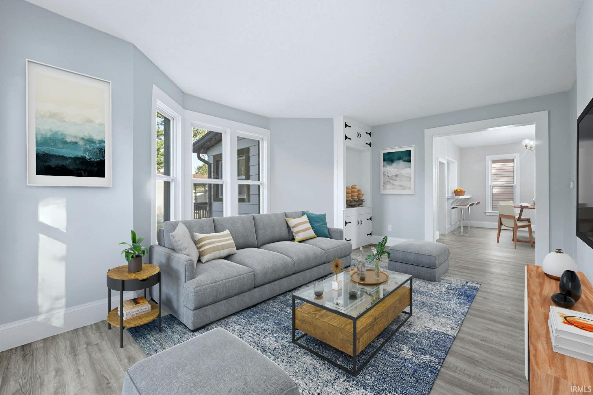 Living room with wood finished floors and healthy amount of natural light