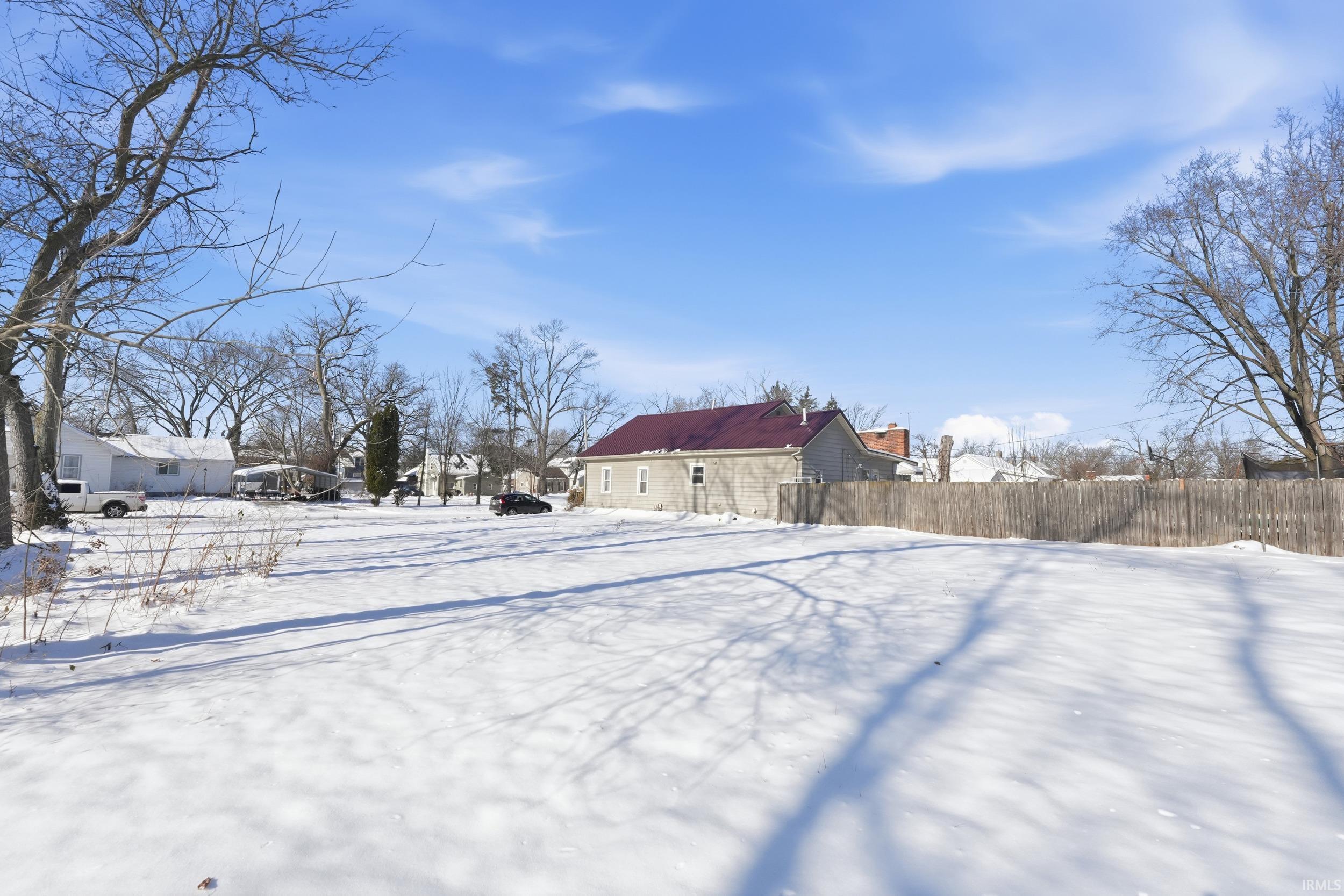 View of yard covered in snow
