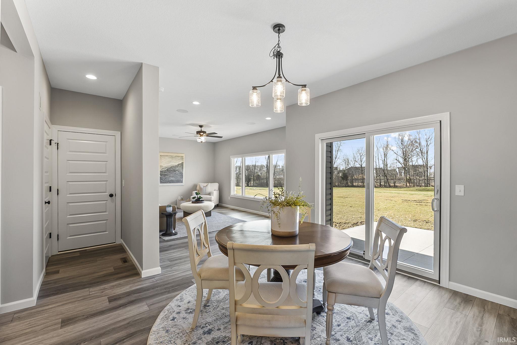 Dining room featuring a ceiling fan, wood finished floors, and suspended lighting