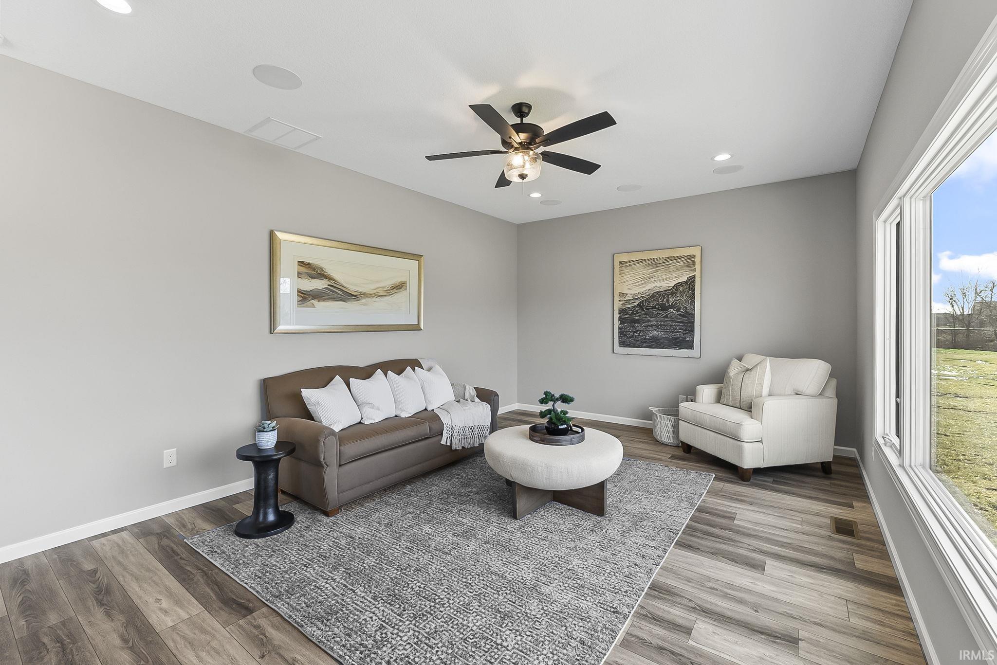 Living room featuring ceiling fan, recessed lighting, and wood finished floors