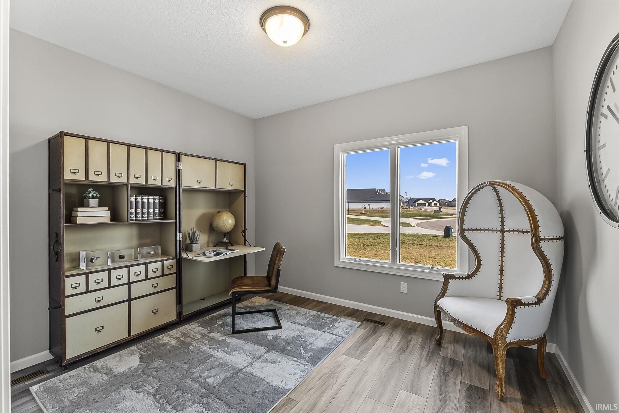Office featuring baseboards and dark wood finished floors