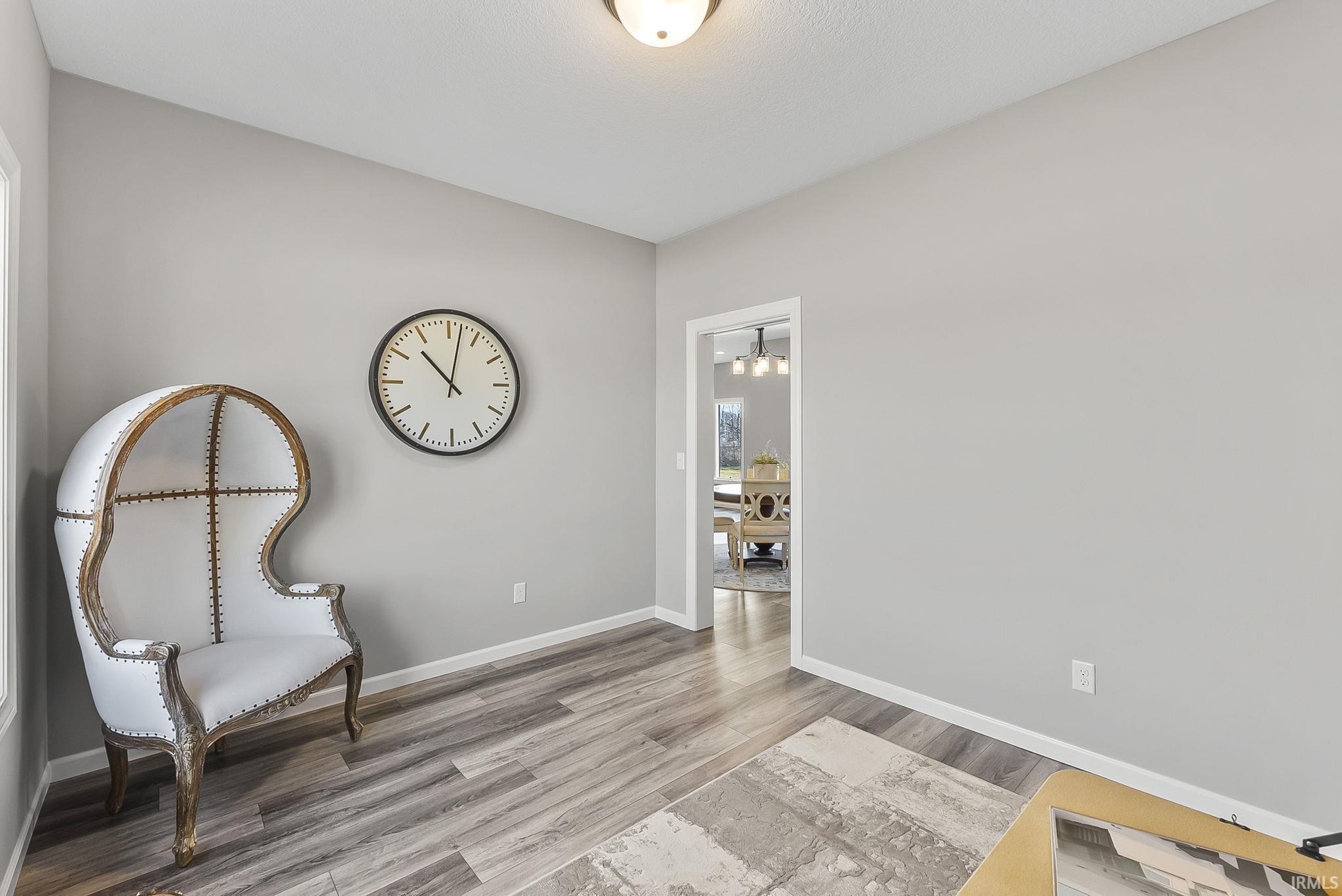 Sitting room with light wood finished floors and baseboards