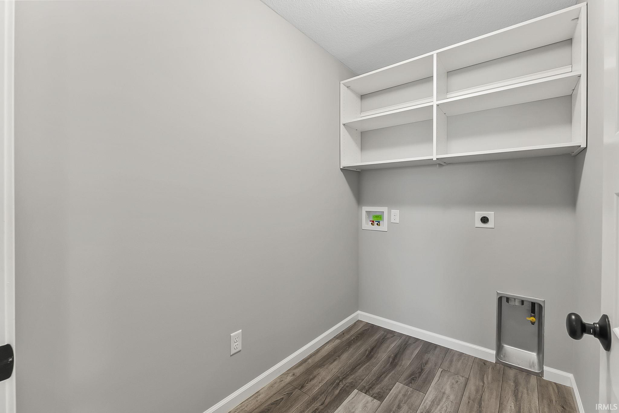 Laundry area with washer hookup, dark wood finished floors, and hookup for an electric dryer