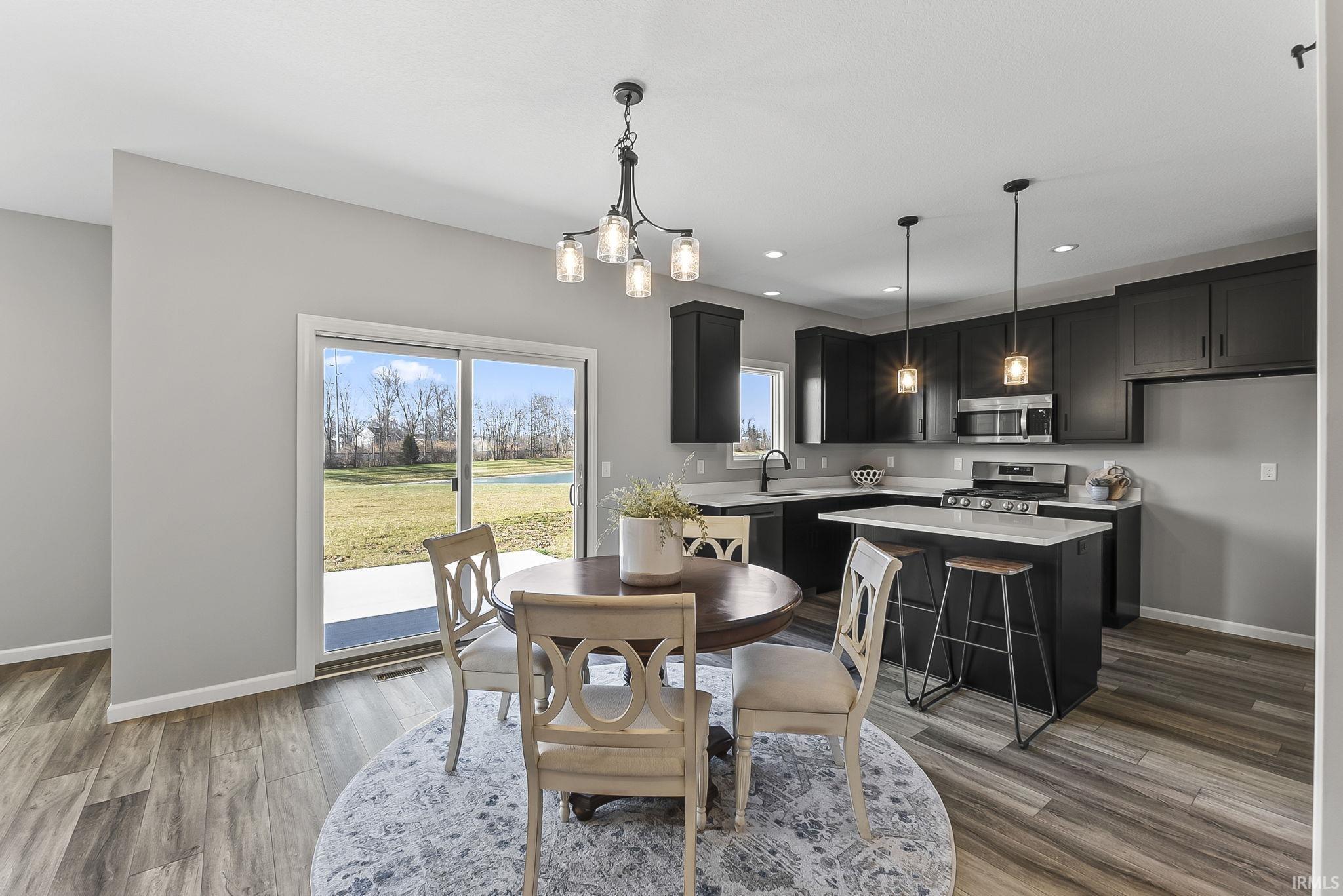 Dining area featuring hanging lights and light wood finished floors
