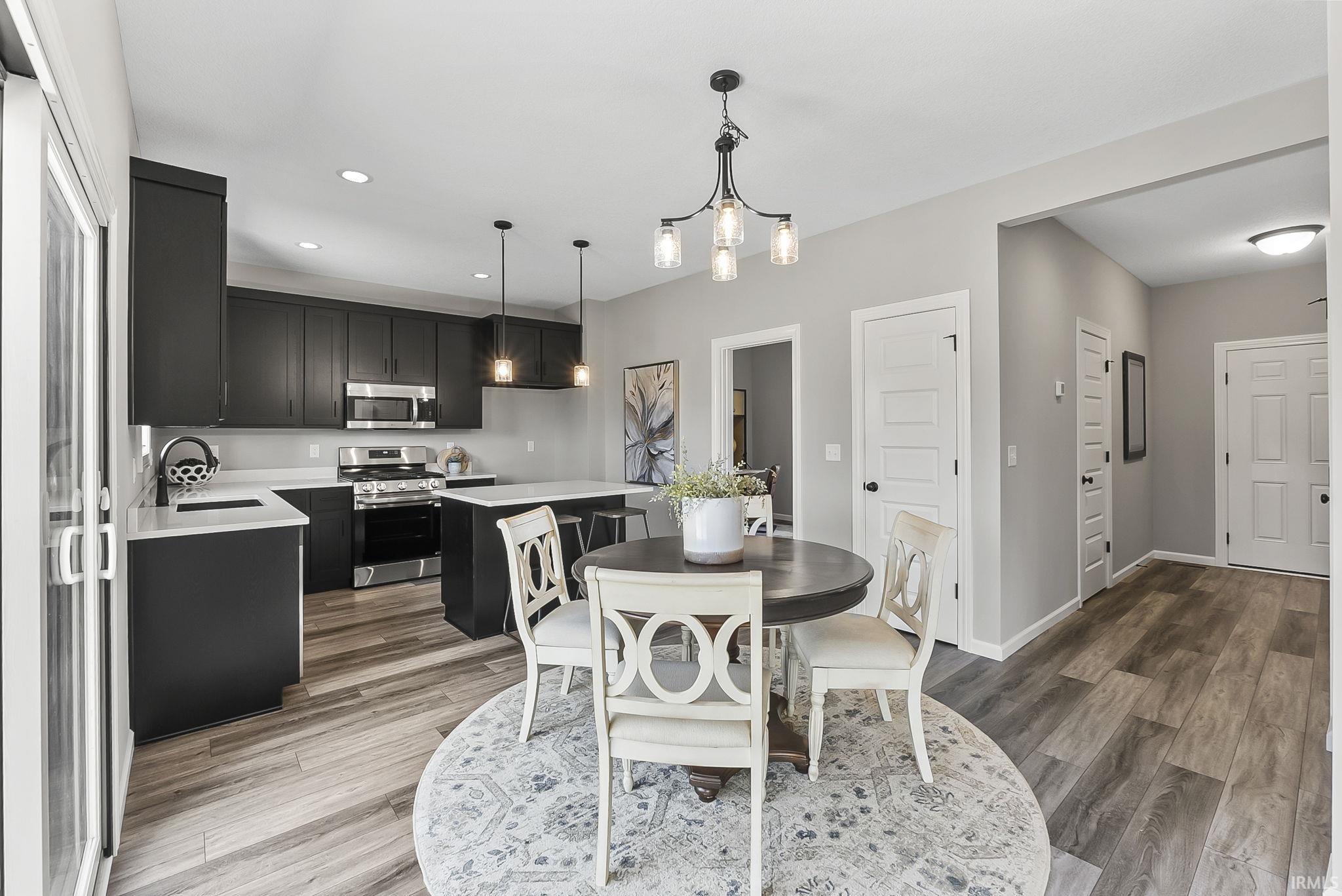 Dining room featuring light wood-type flooring and a chandelier