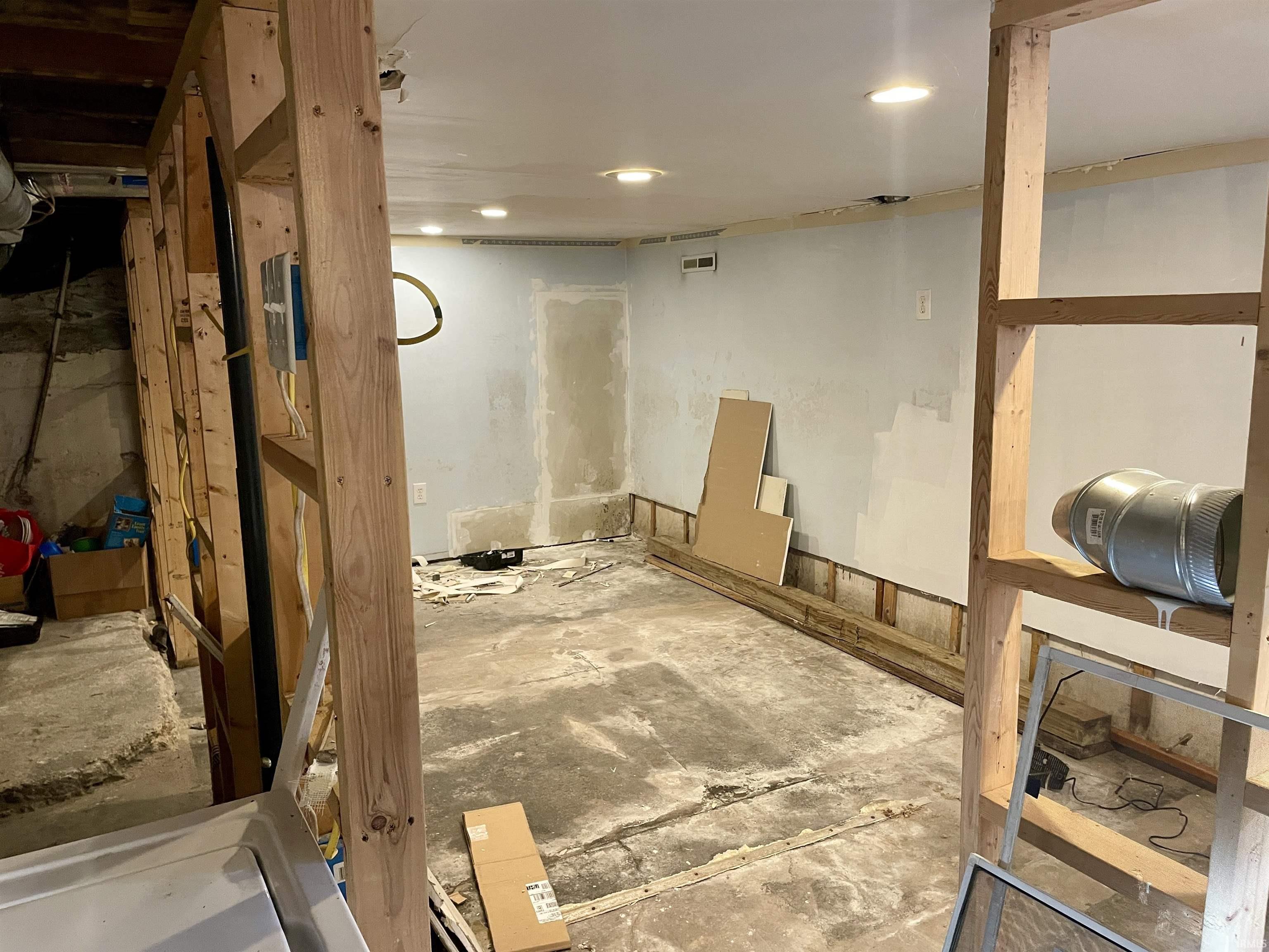 Unfinished below grade area featuring recessed lighting