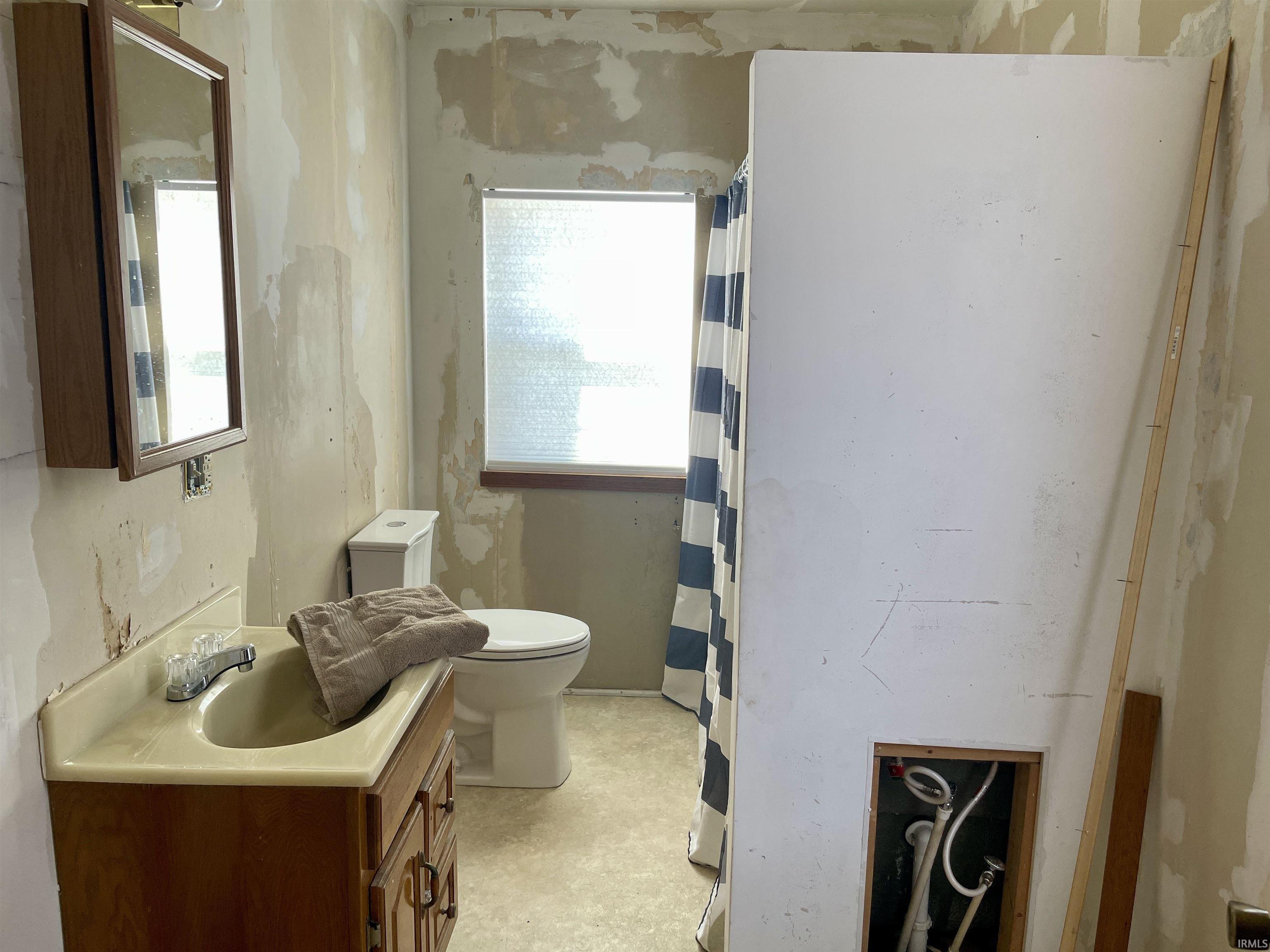 Full bathroom featuring vanity and curtained shower