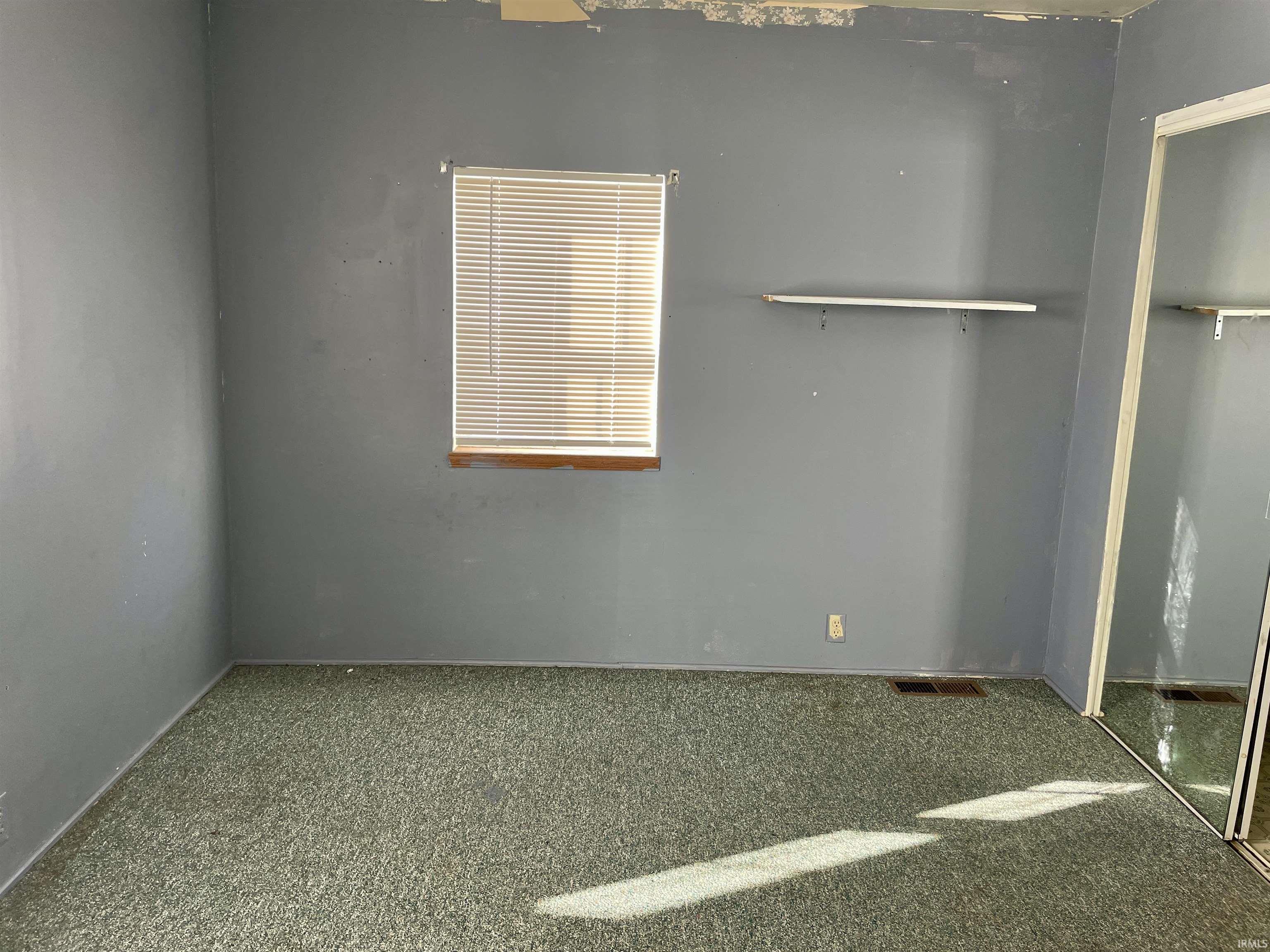 Unfurnished bedroom with carpet and a closet