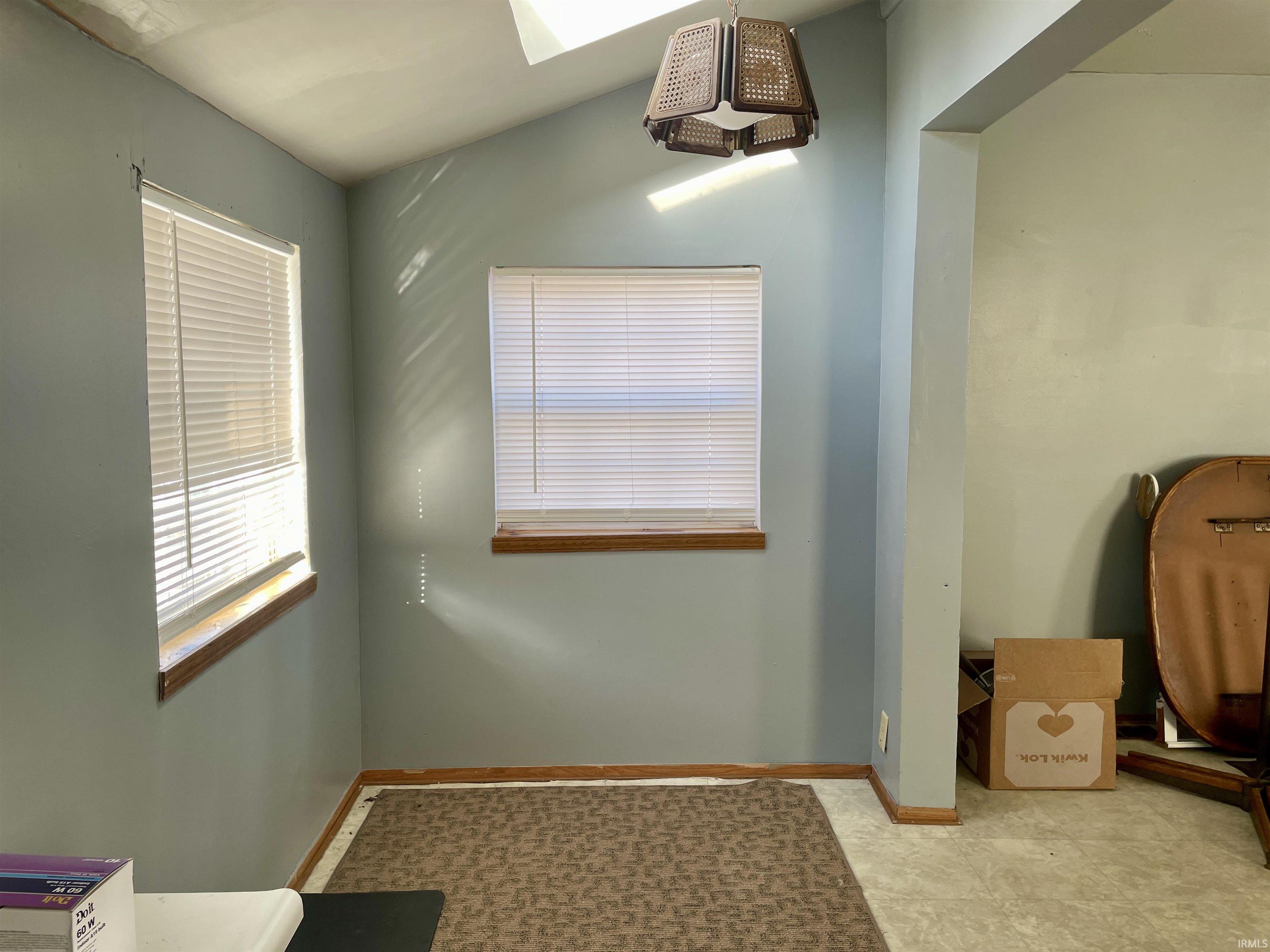 Bathroom with baseboards and a skylight