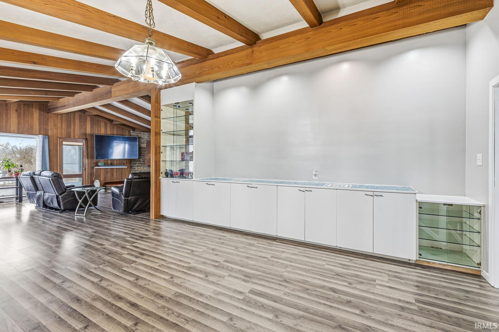 Dining space featuring light wood-style flooring and wood walls
