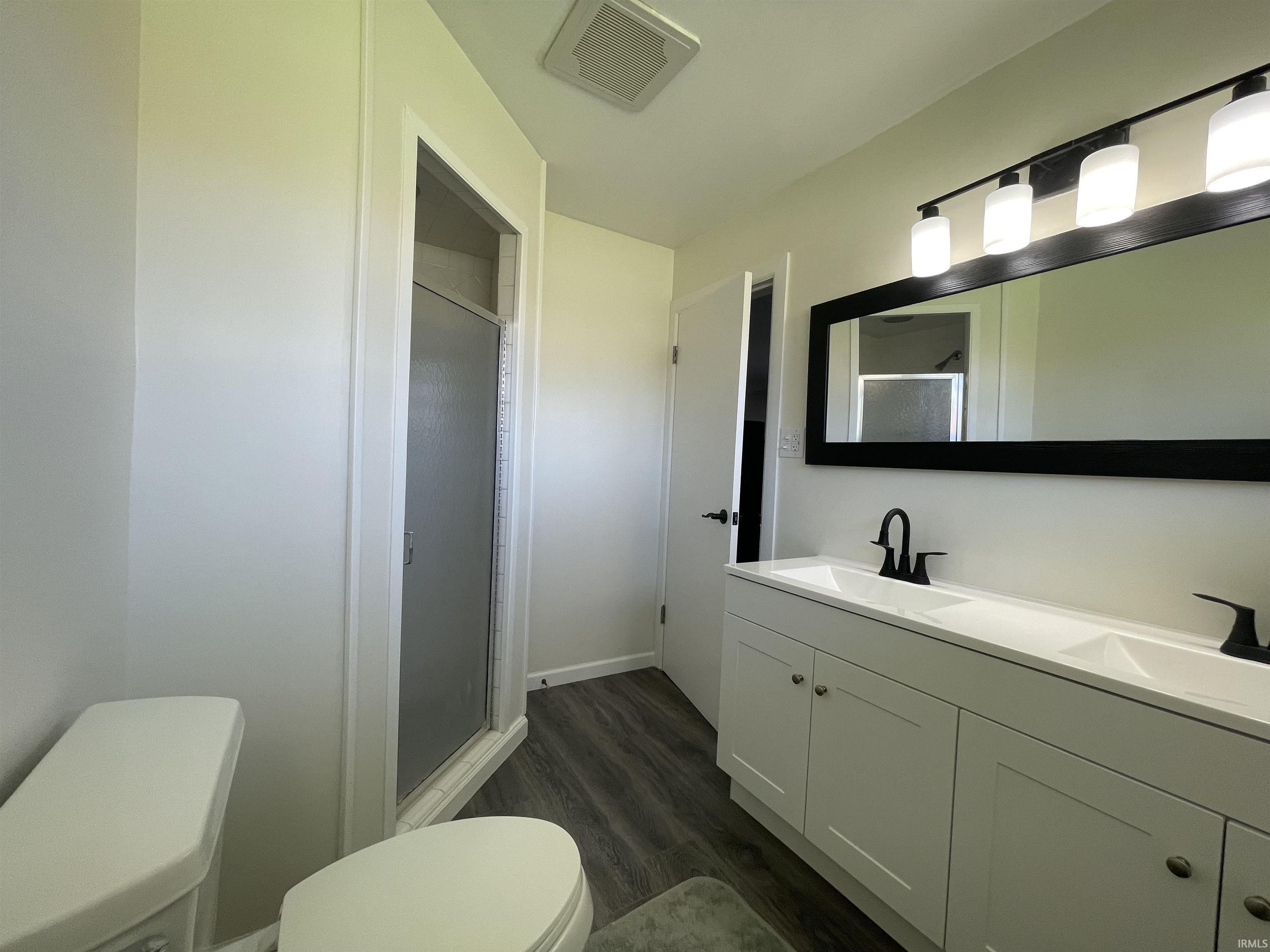 Full bath with vanity and tile walls