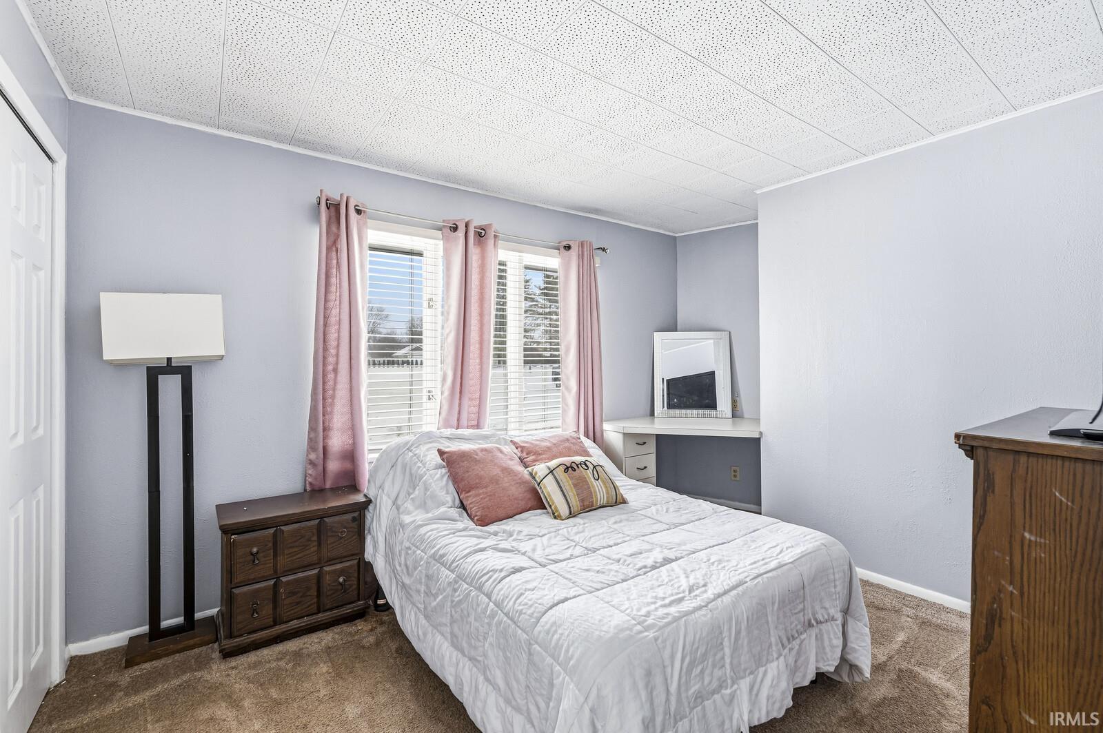 Bedroom featuring carpet flooring, and a closet.
