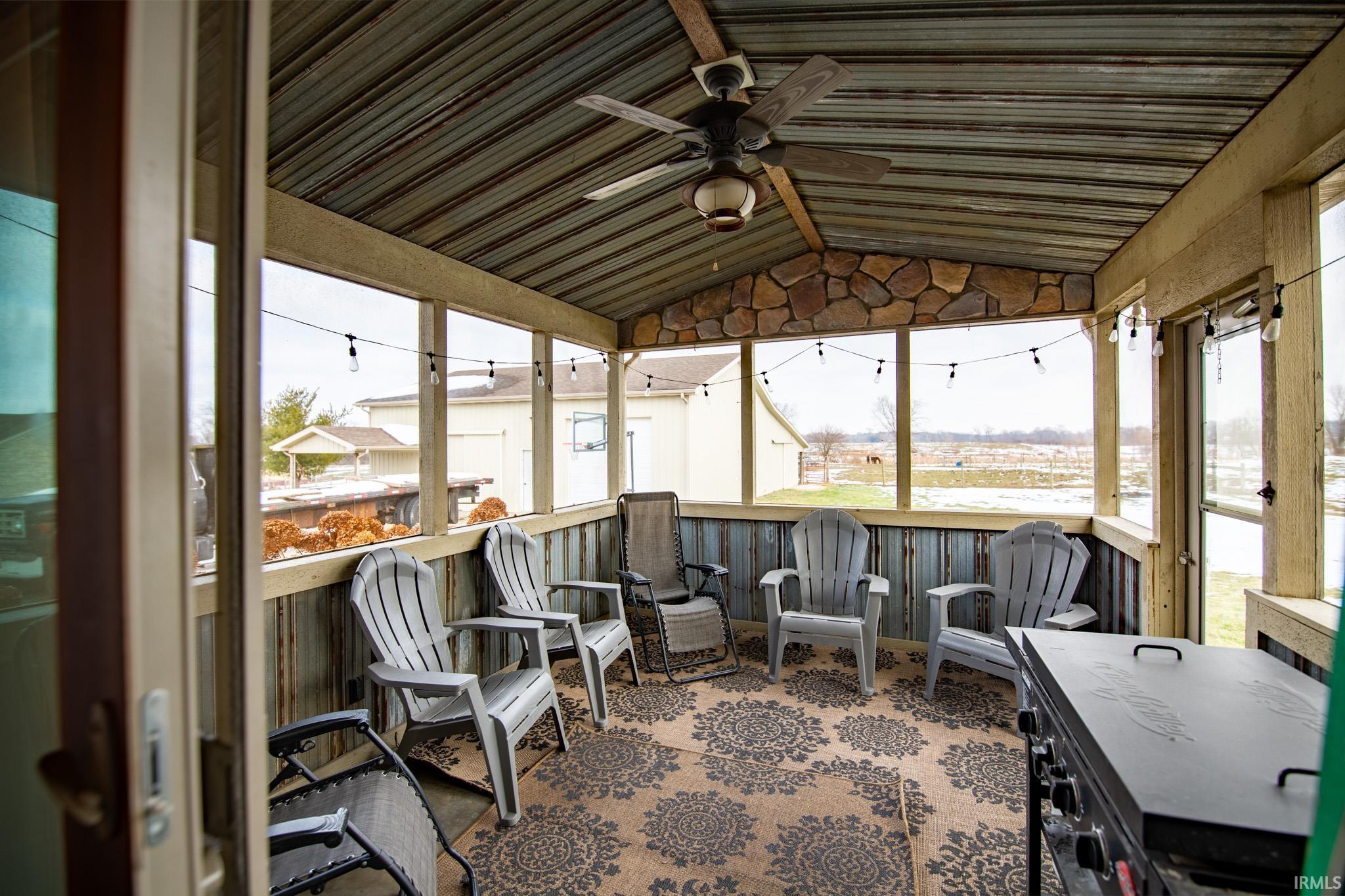 Sunroom / solarium with ceiling fan and lofted ceiling