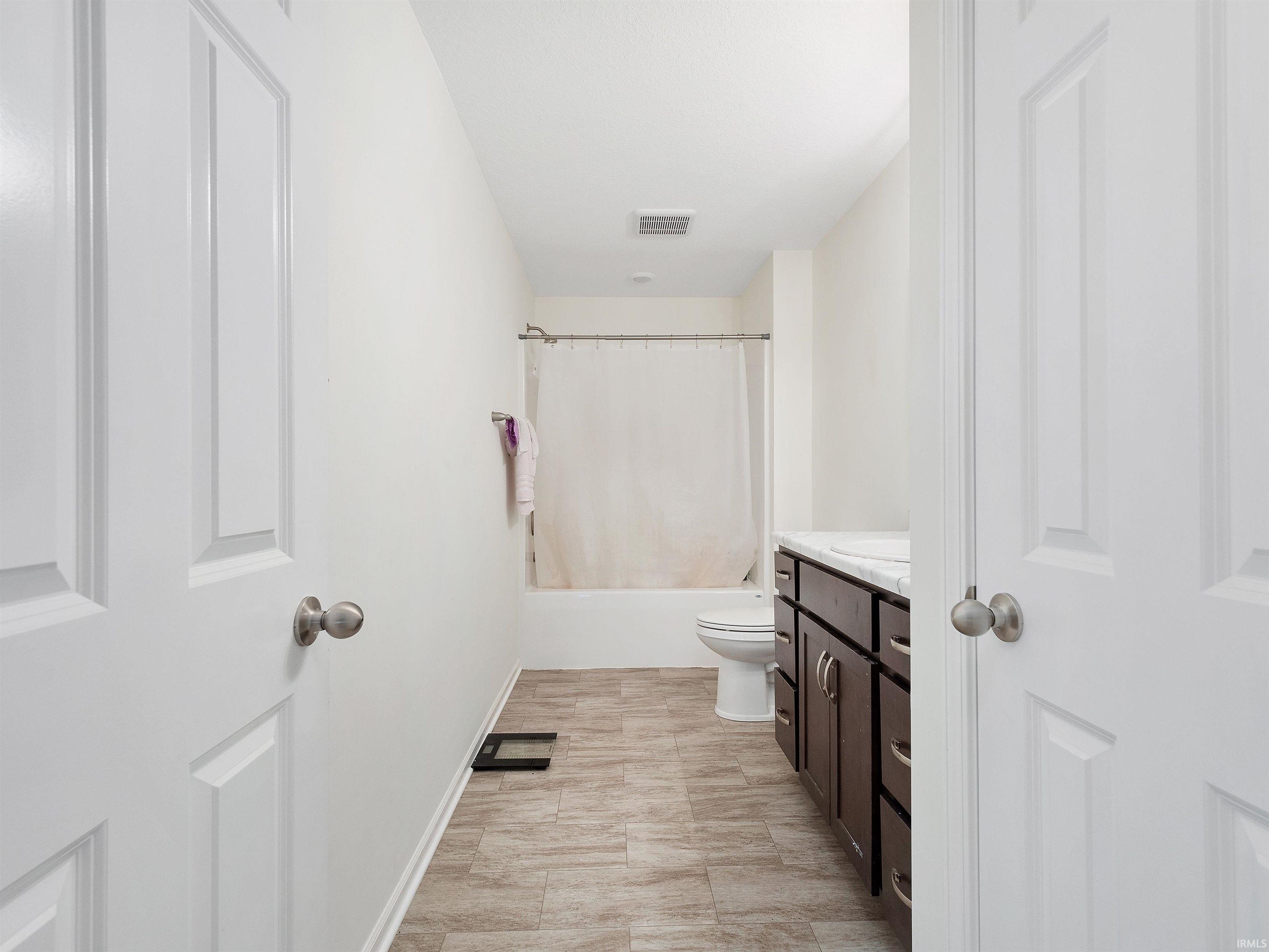 Full bath with vanity and shower / bathtub combination with curtain