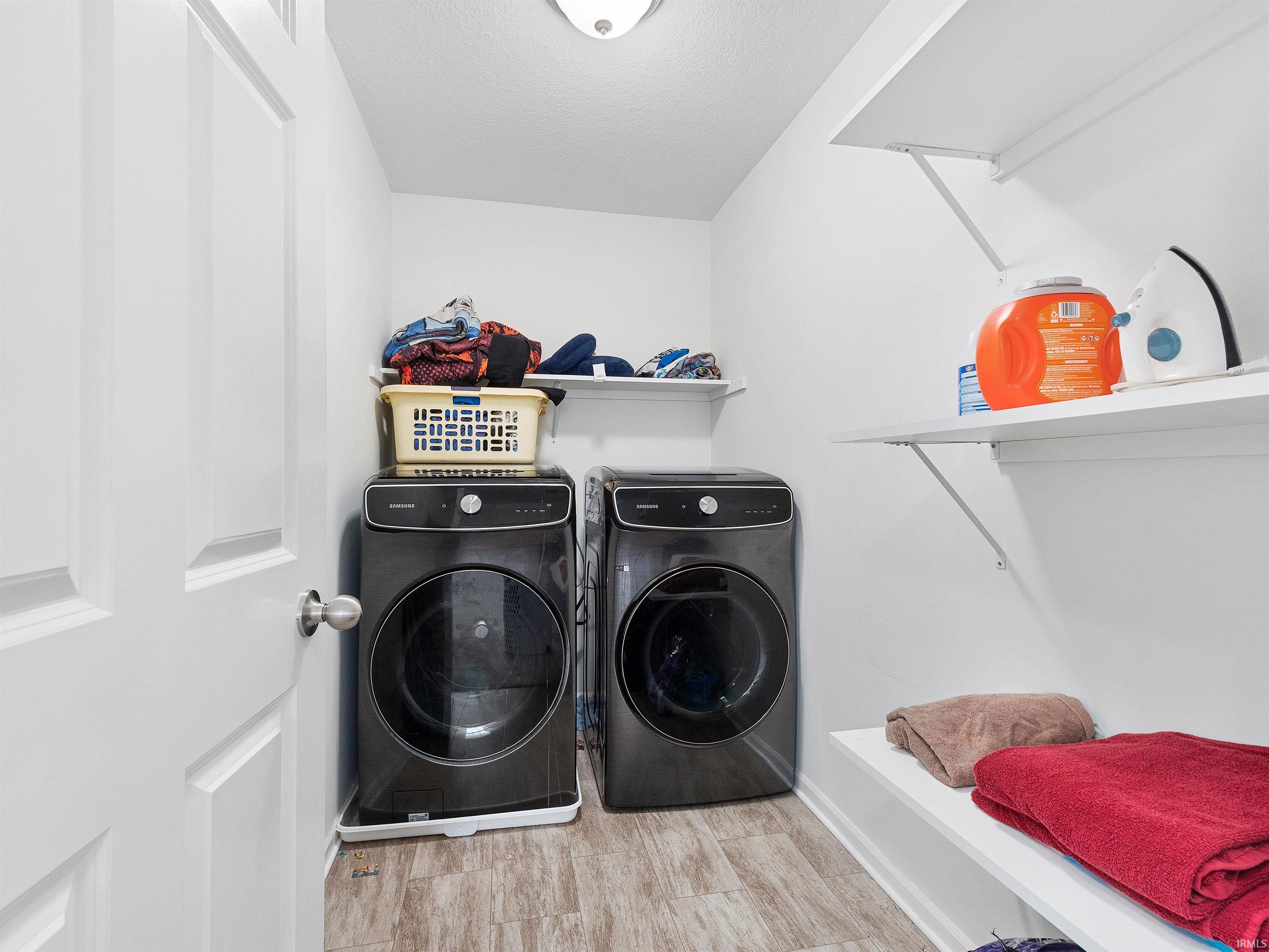 Washroom featuring light wood-style floors and independent washer and dryer