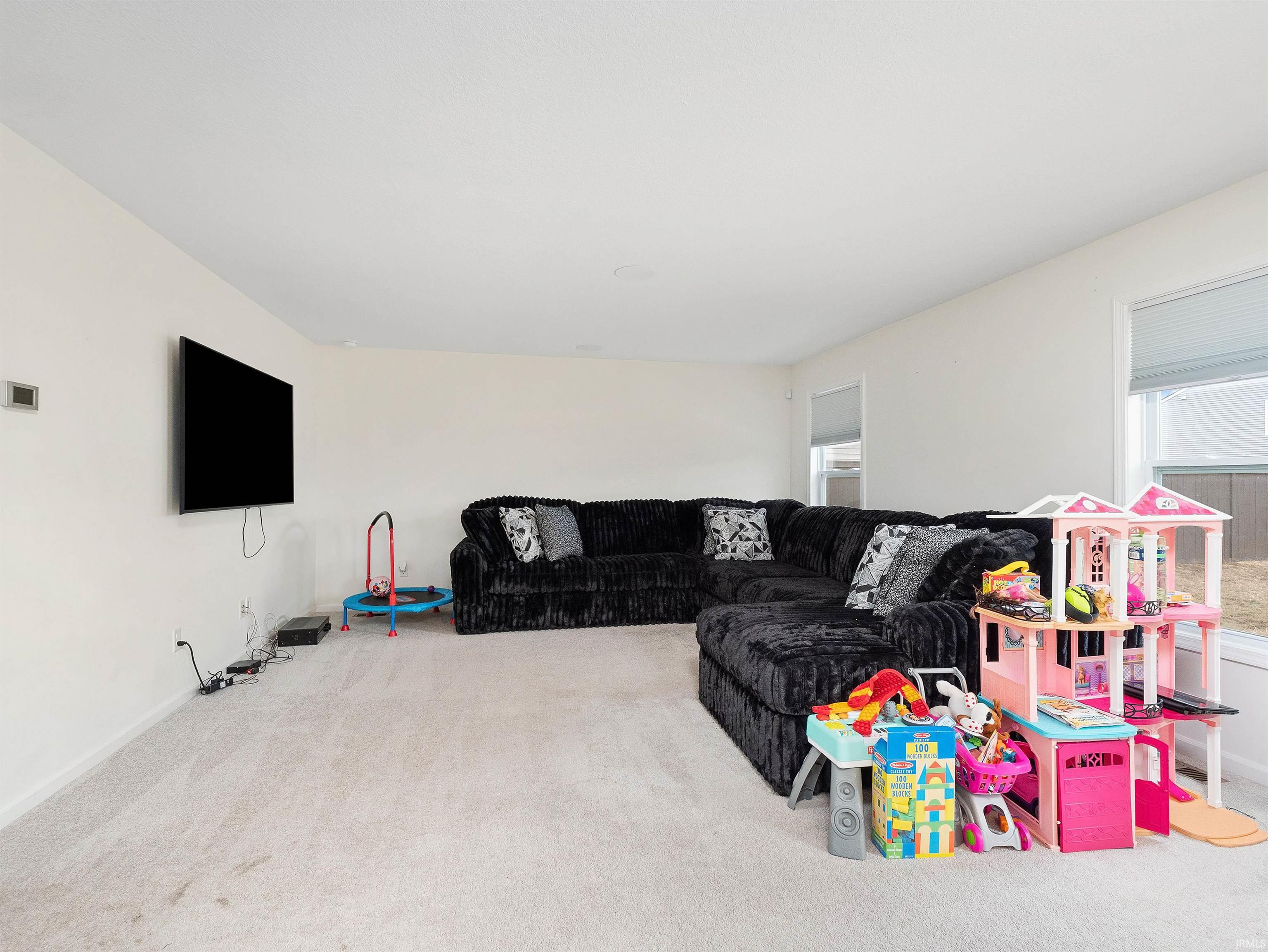 Carpeted living room featuring baseboards