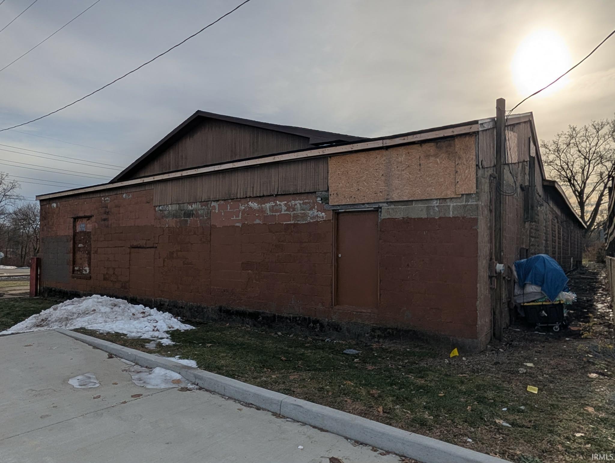 View of side of property with concrete block siding