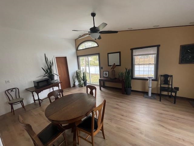 living room with light wood finished floors and ceiling fan