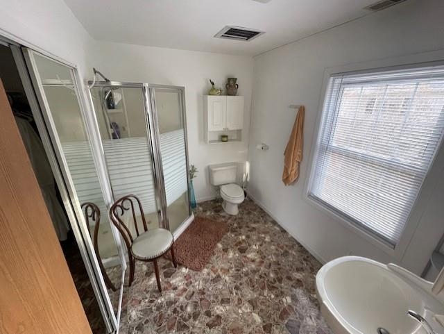 Full bathroom with a shower stall and toilet