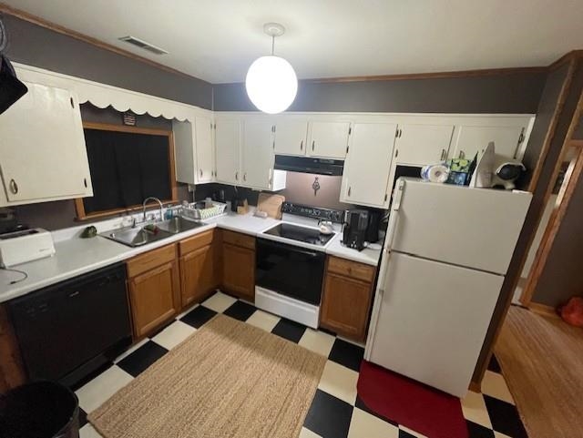 Kitchen with light flooring, light countertops, freestanding refrigerator, electric stove, and dishwasher