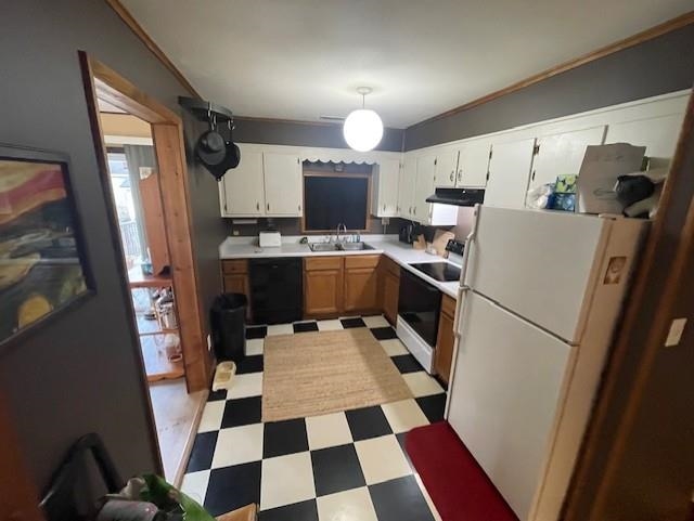 Kitchen with light flooring, white appliances, light countertops, decorative light fixtures, and ornamental molding