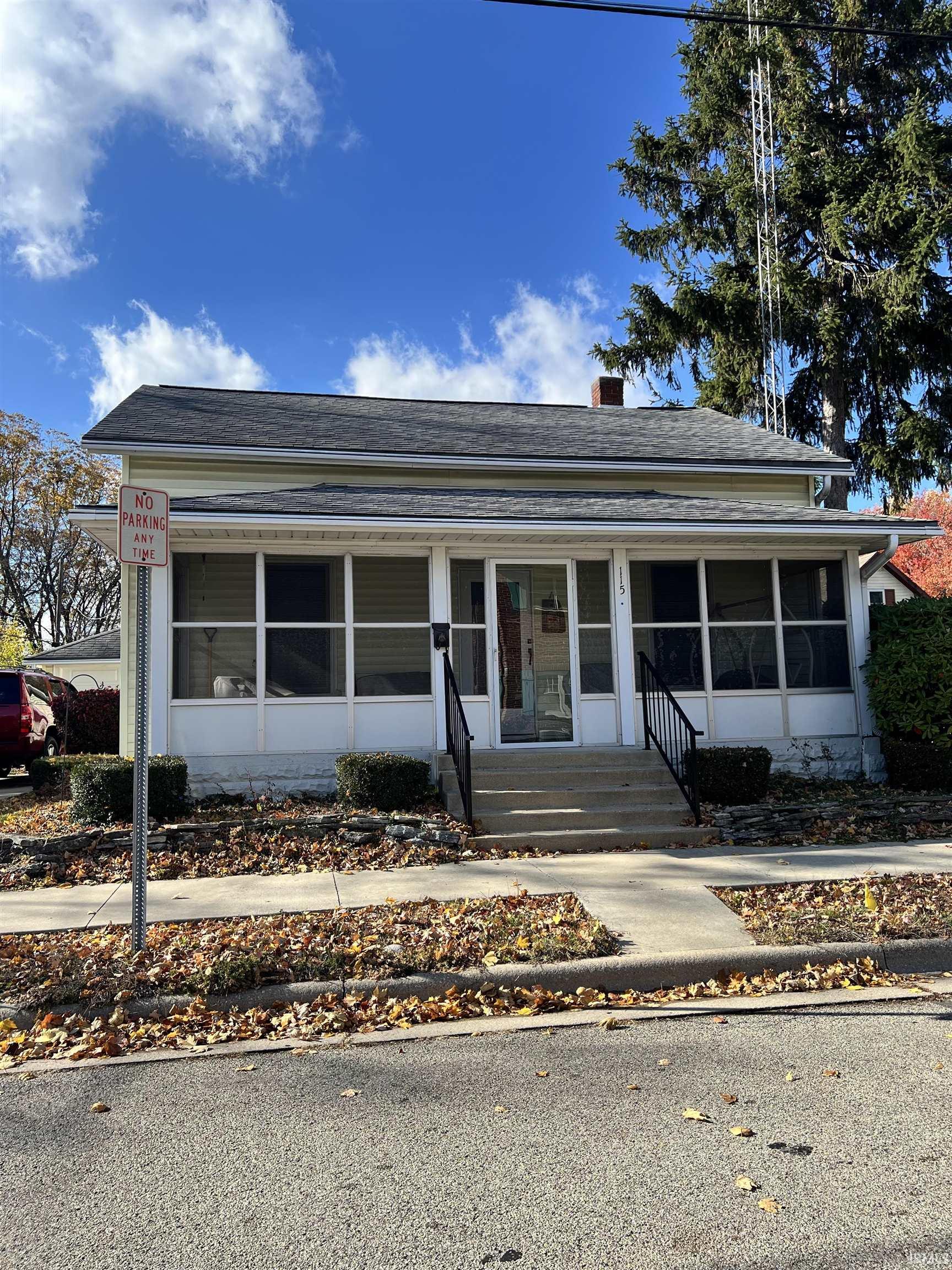 Bungalow-style house with a chimney, a porch, and entry steps