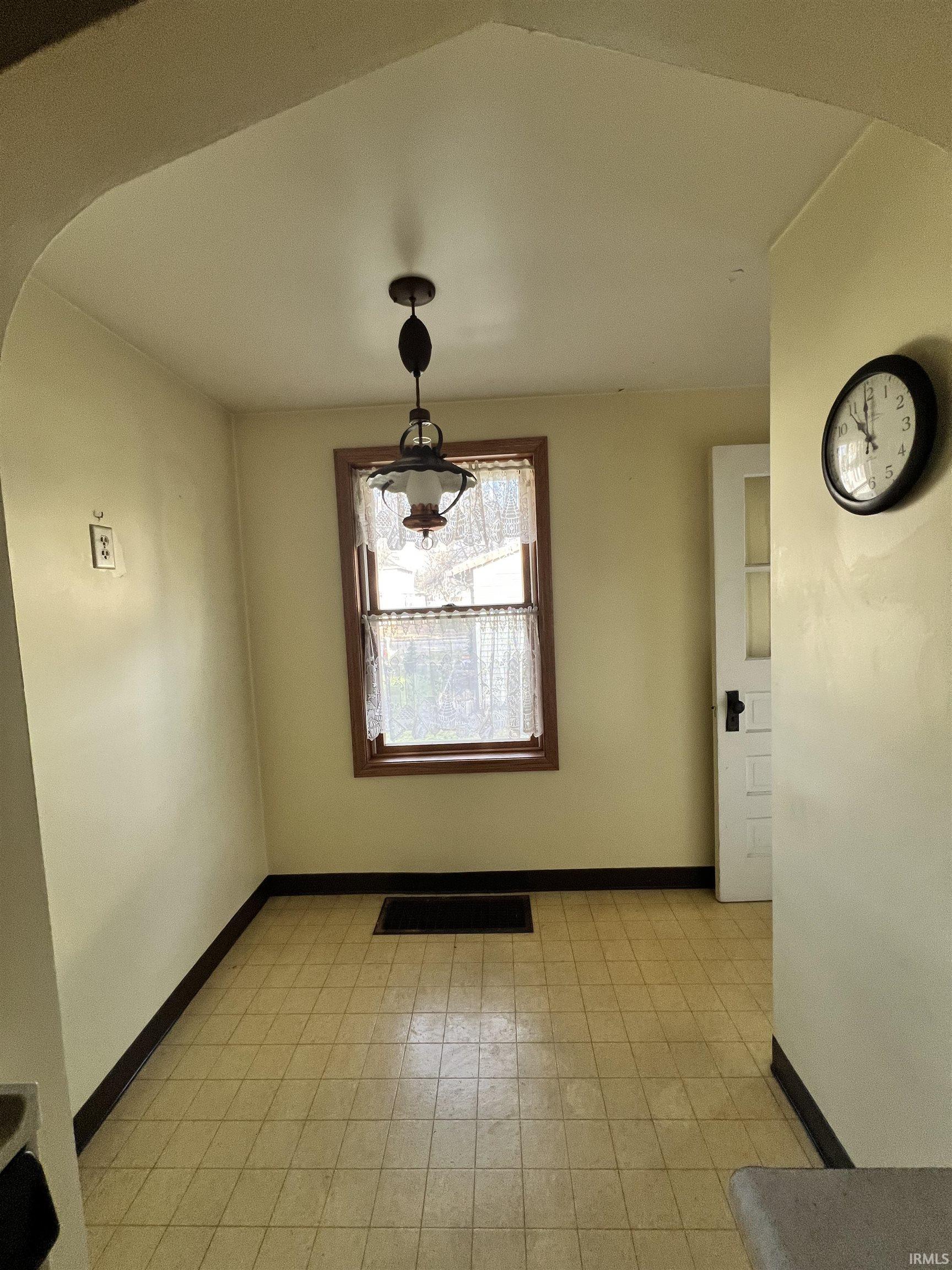 Unfurnished dining area with baseboards
